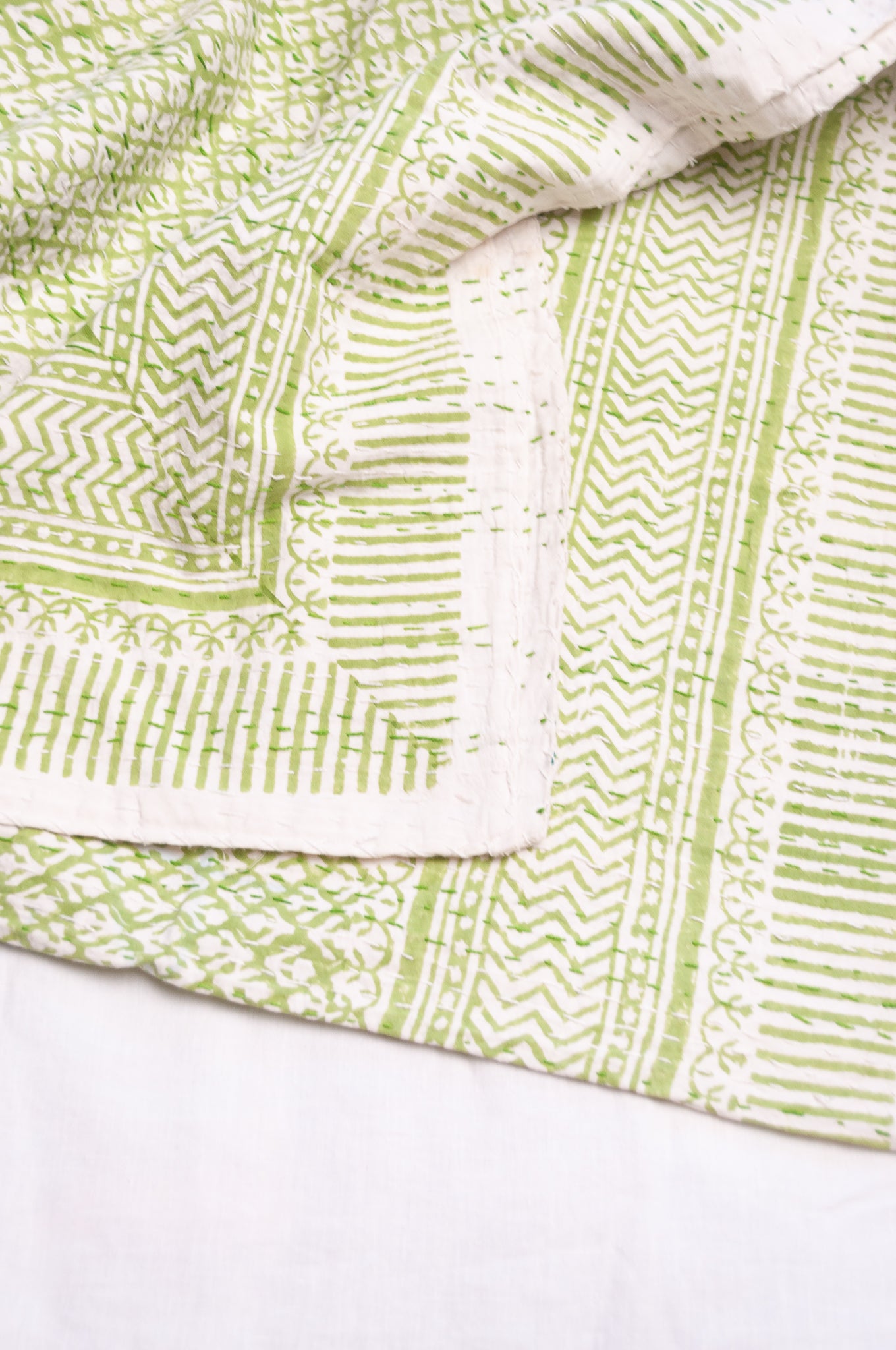 Cotton kantha quilt in lime green and white small floral.