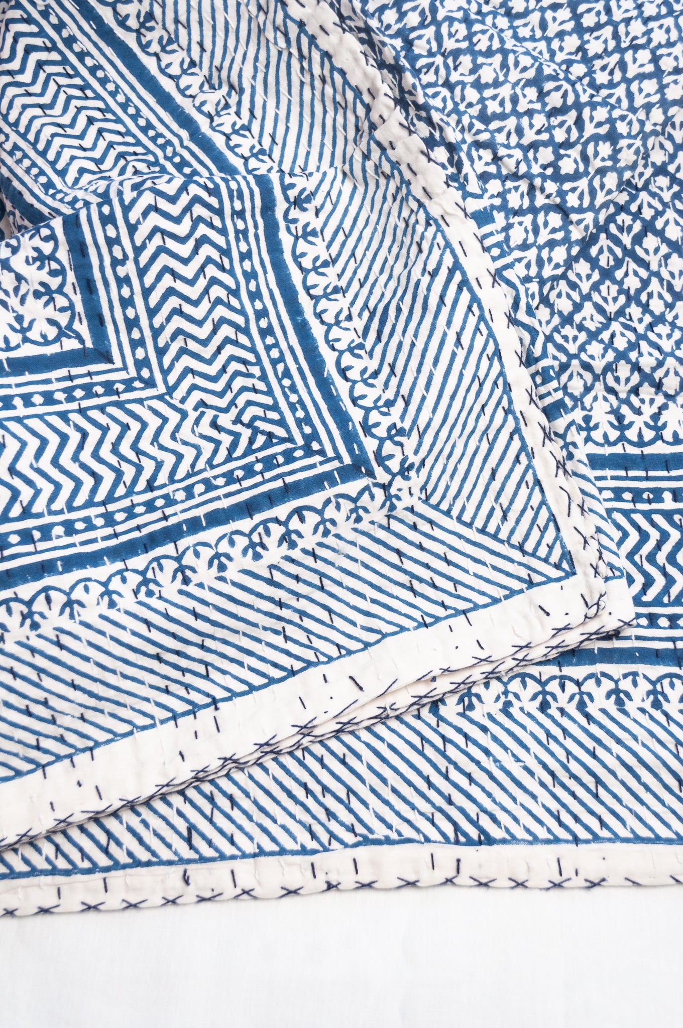 Cotton kantha quilt in indigo blue and white small floral.