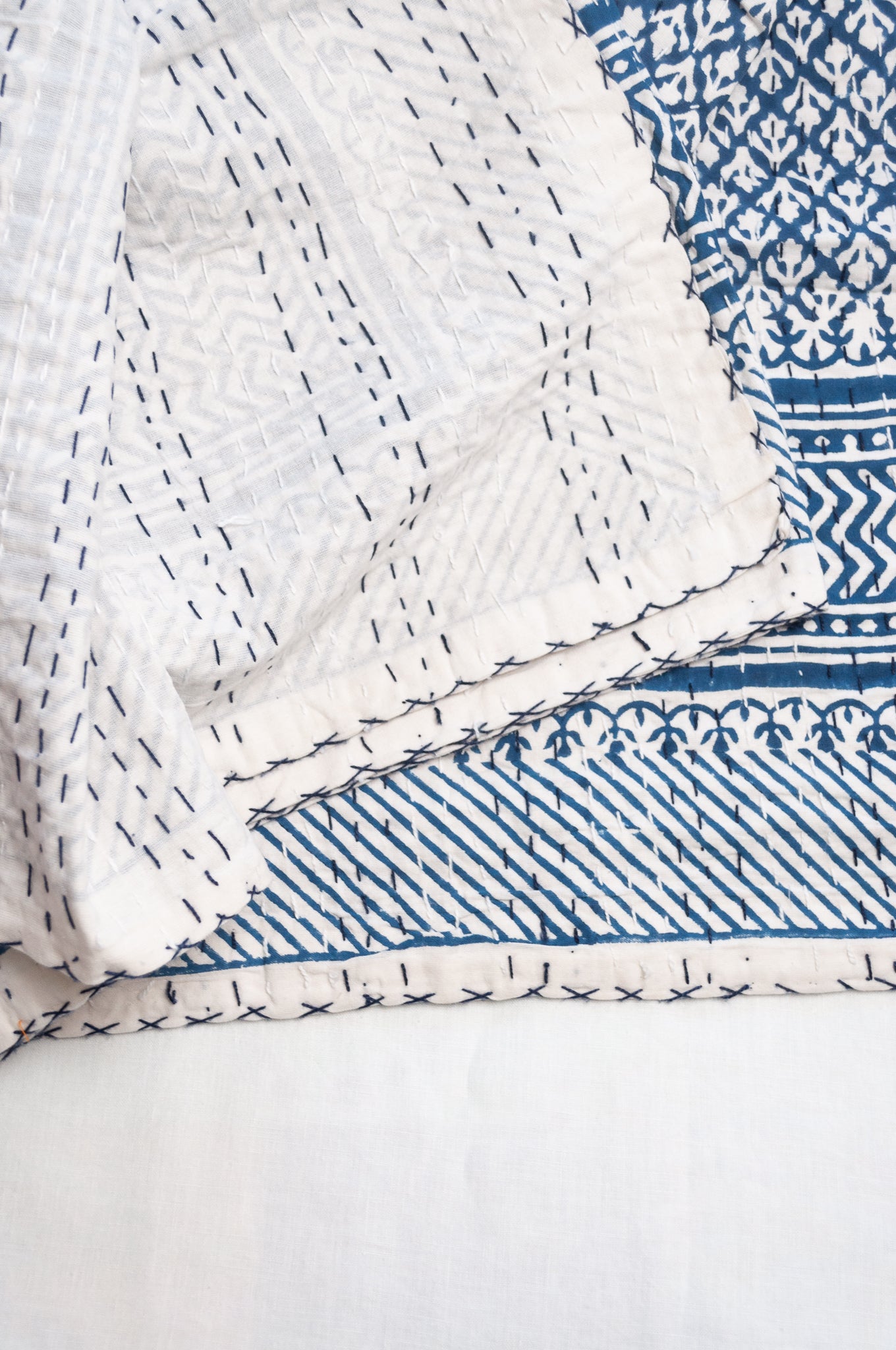 Cotton kantha quilt in indigo blue and white small floral.