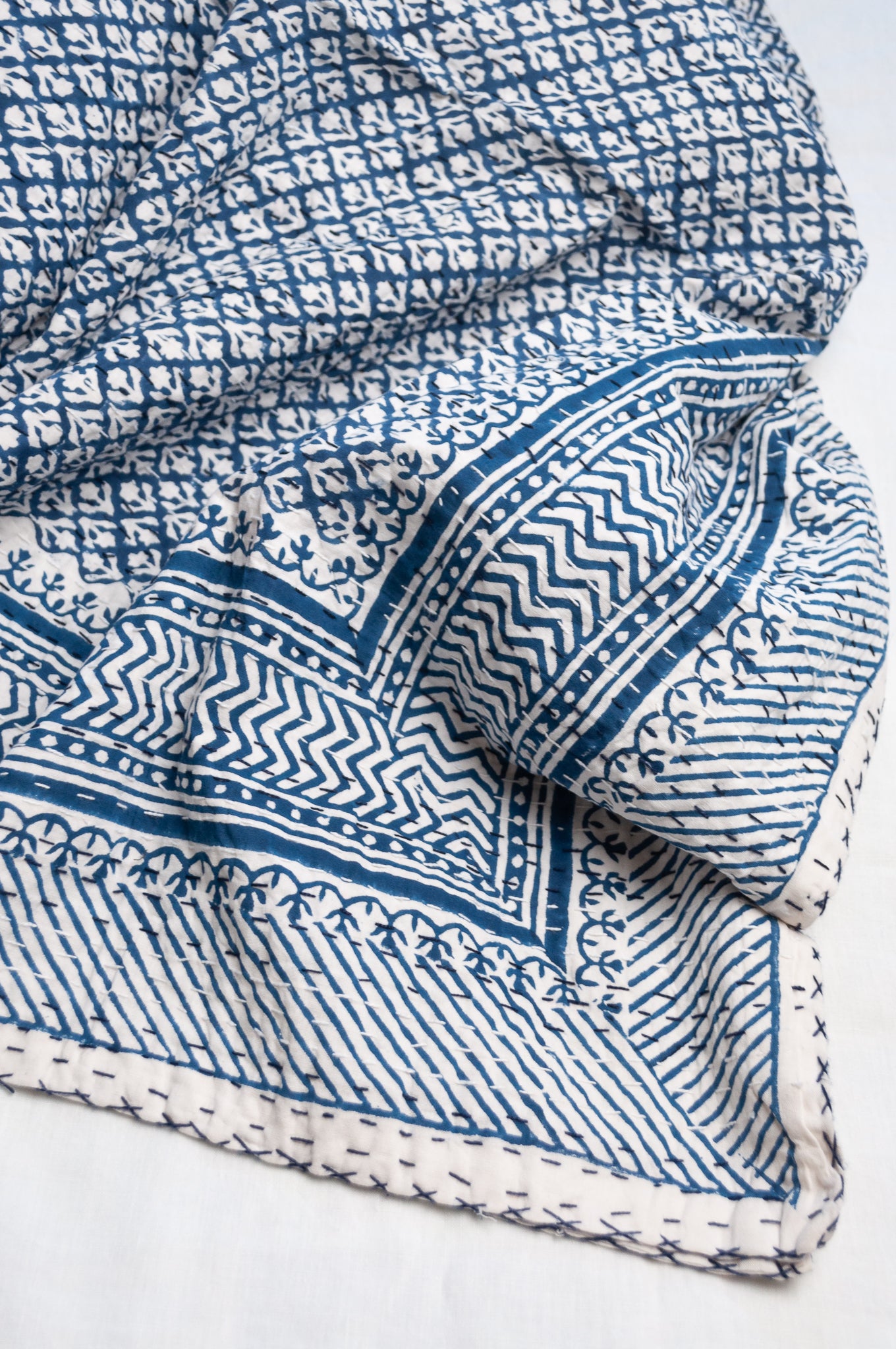 Cotton kantha quilt in indigo blue and white small floral.