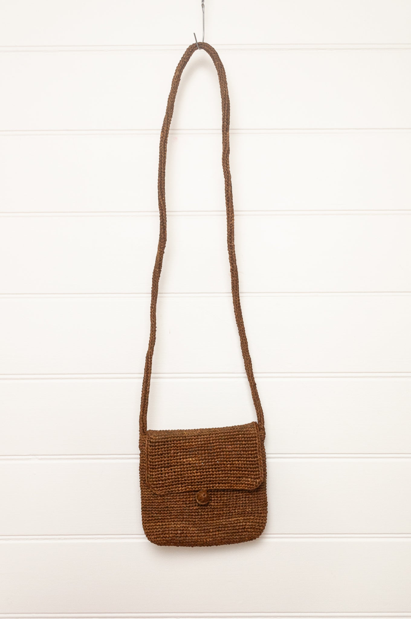 Sophie Digard small cross body crocheted raffia bag in tobacco brown.
