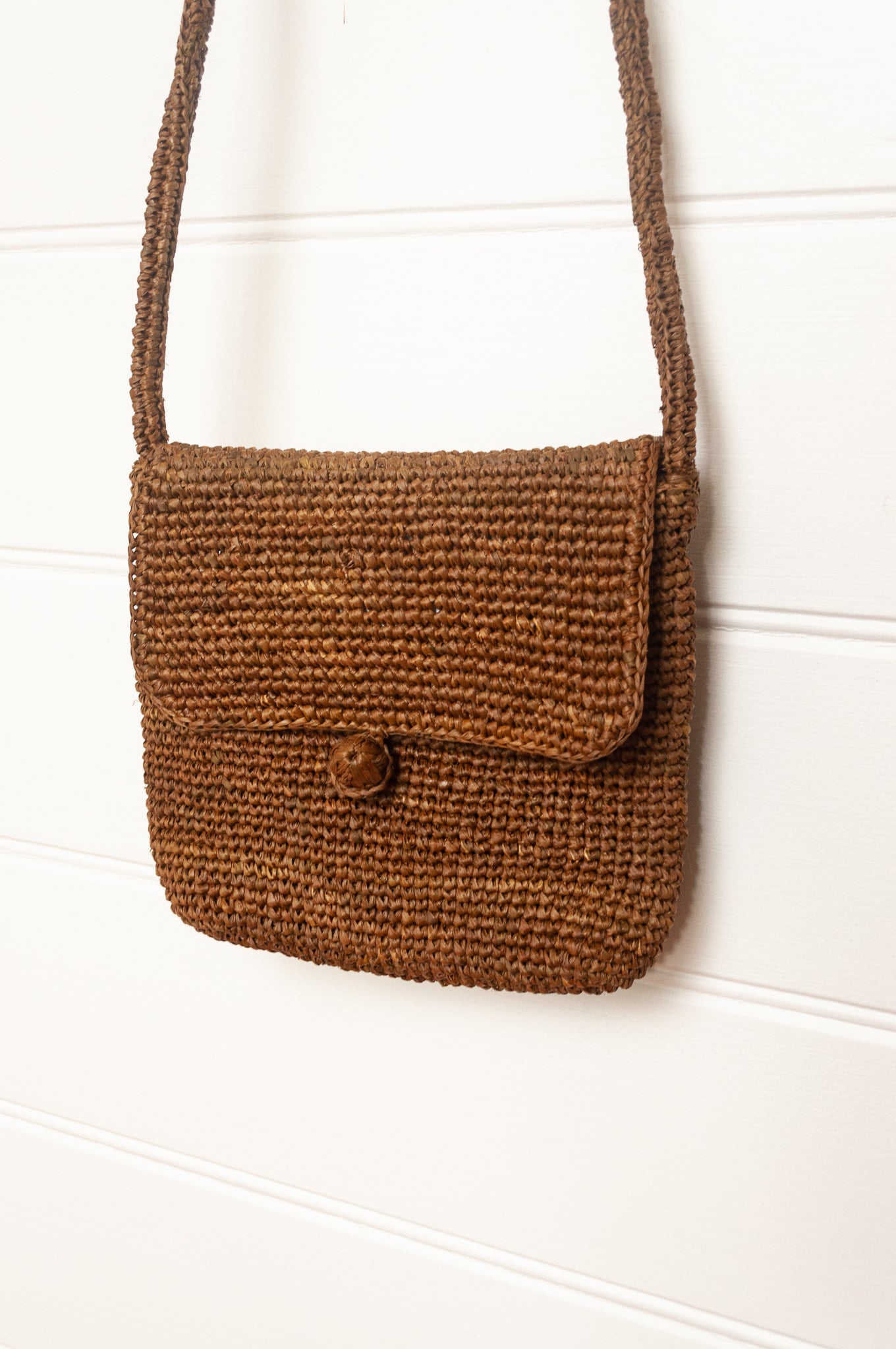 Sophie Digard small cross body crocheted raffia bag in tobacco brown.