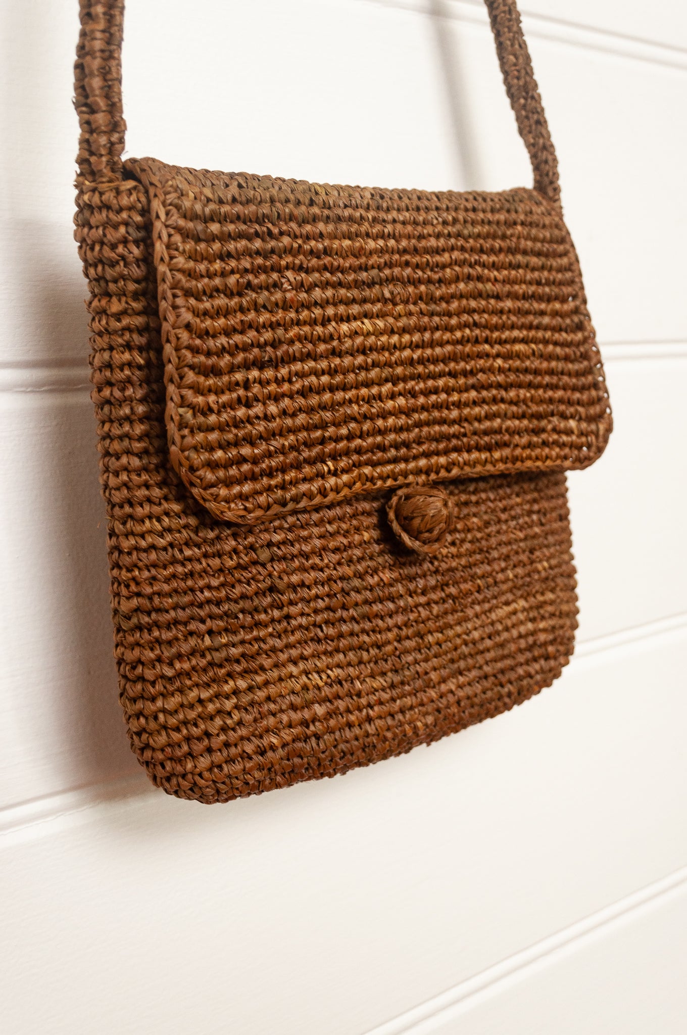 Sophie Digard small cross body crocheted raffia bag in tobacco brown.