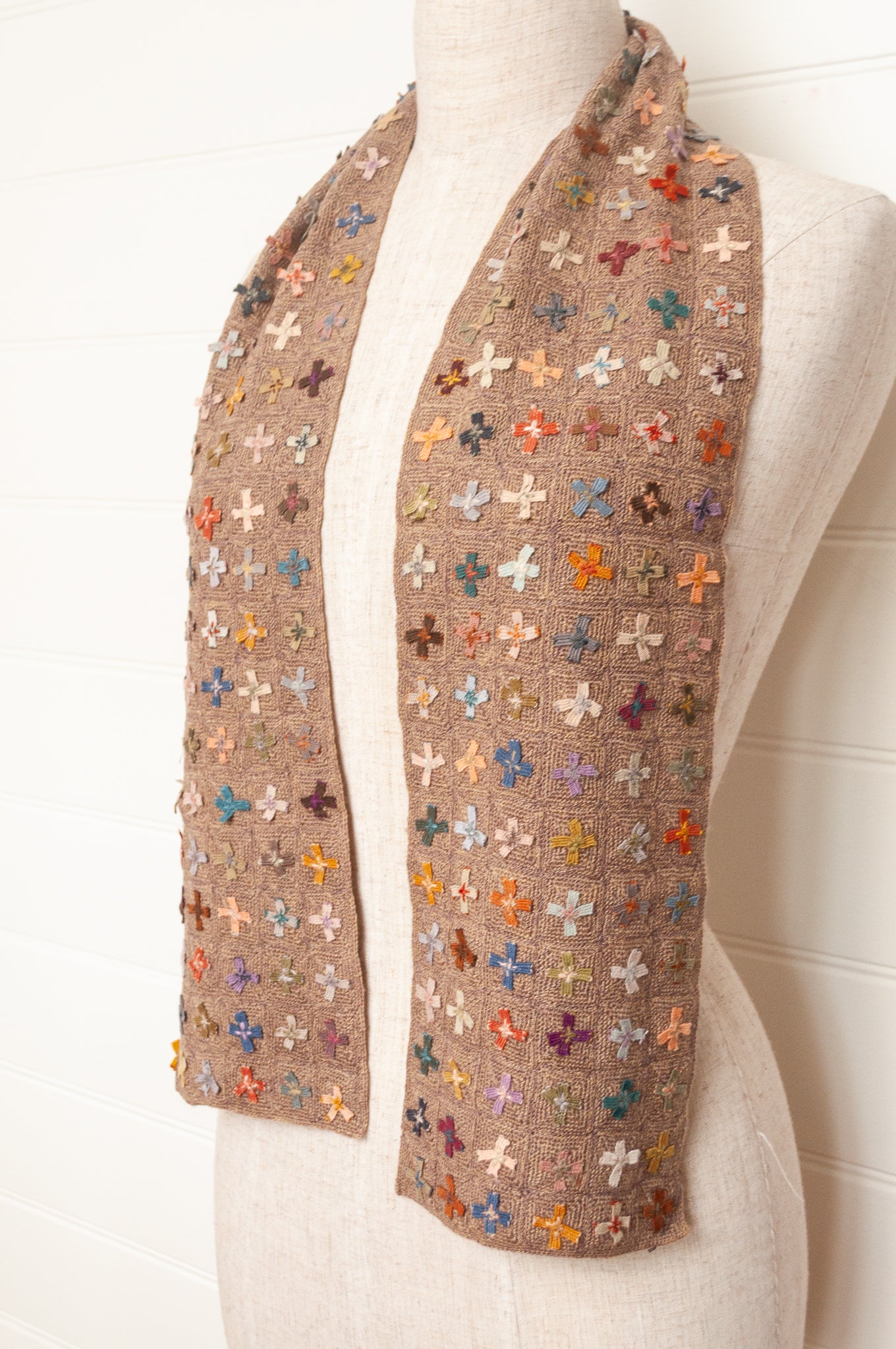 Sophie Digard crochet scarf of multi coloured four petal flowers on nutmeg brown base.
