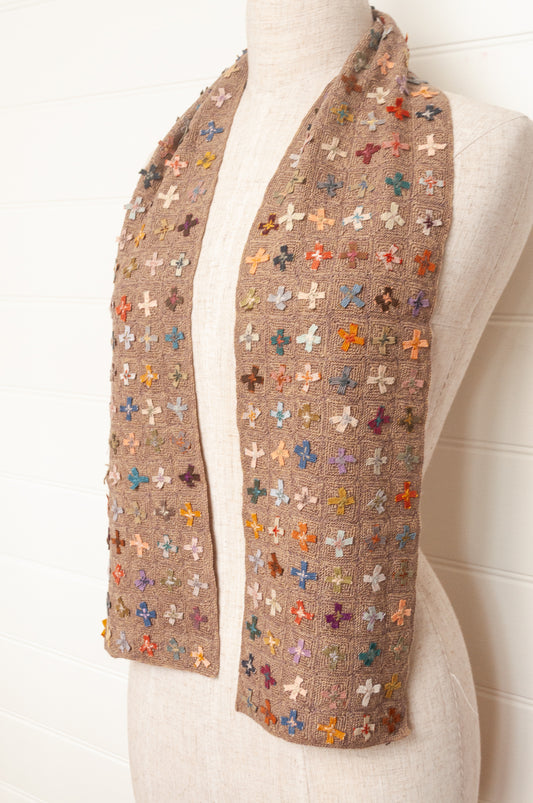 Sophie Digard crochet scarf of multi coloured four petal flowers on nutmeg brown base.