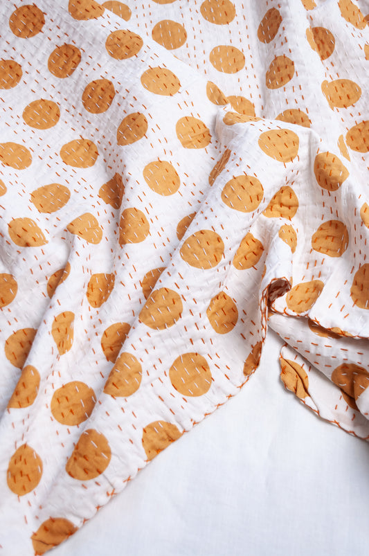 Indigo mustard spot on white cotton kantha quilt.