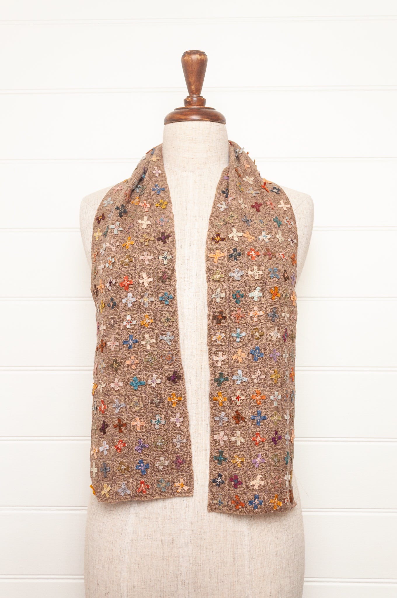 Sophie Digard crochet scarf of multi coloured four petal flowers on nutmeg brown base.