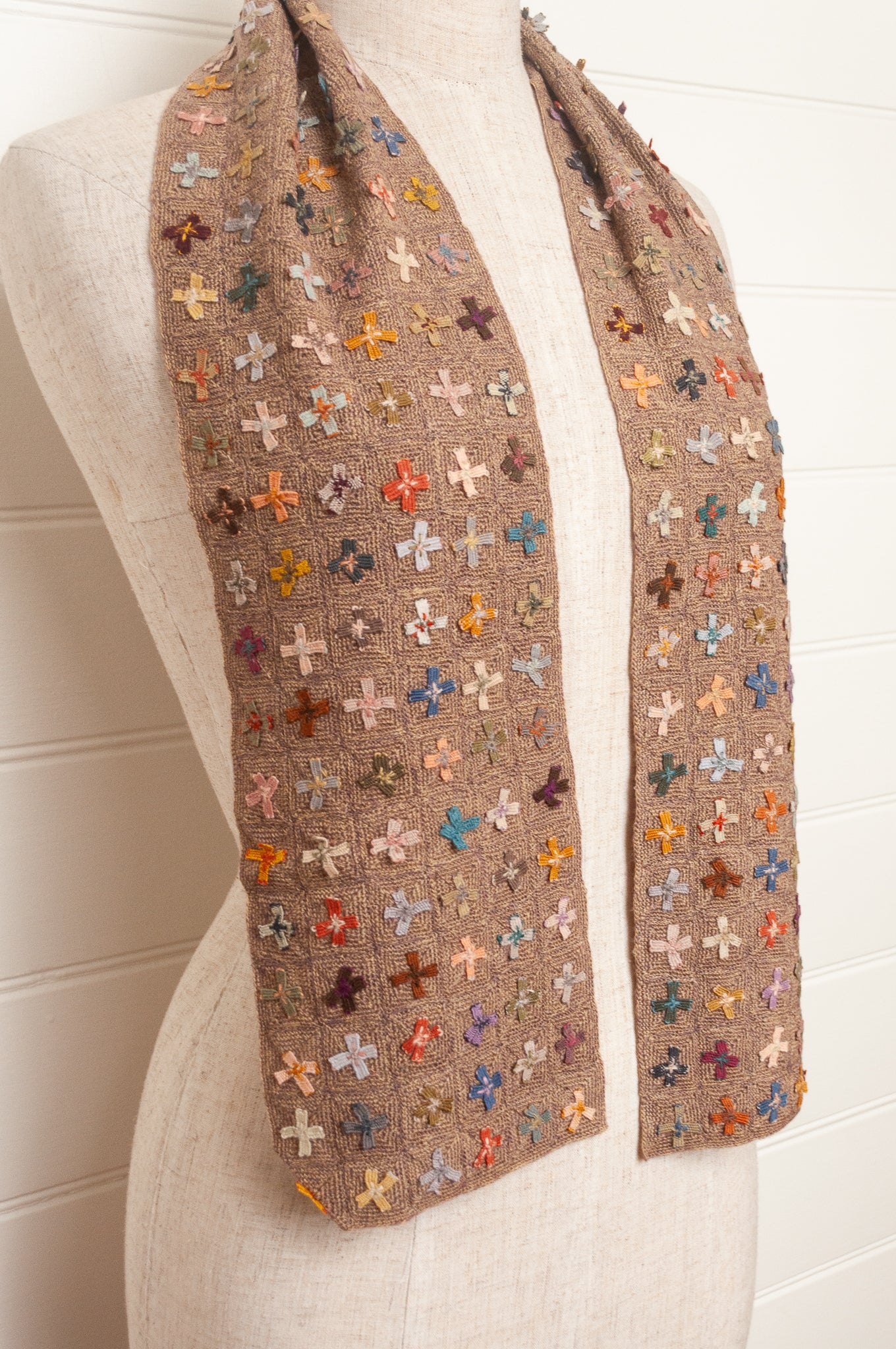 Sophie Digard crochet scarf of multi coloured four petal flowers on nutmeg brown base.