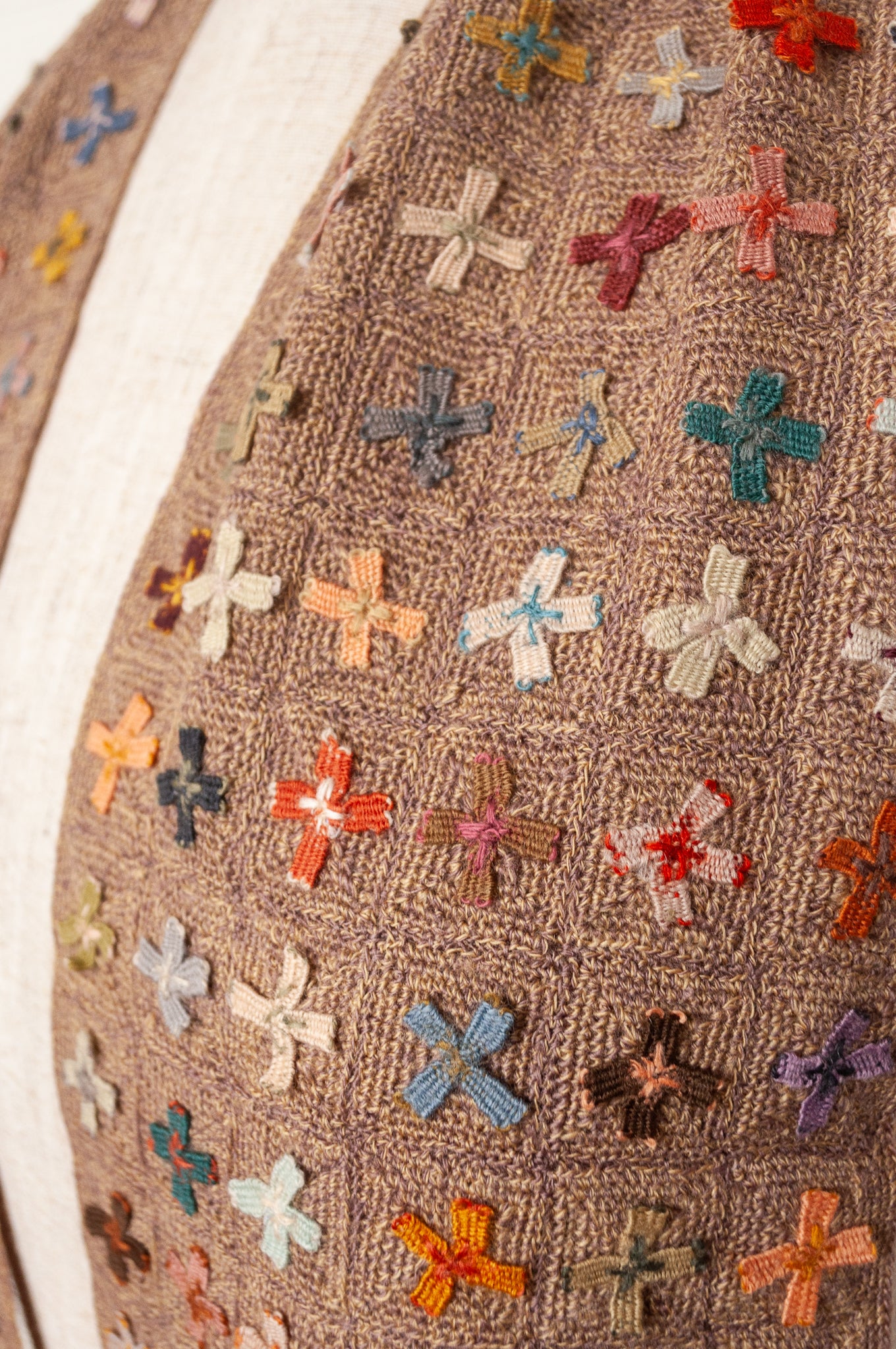 Sophie Digard crochet scarf of multi coloured four petal flowers on nutmeg brown base.