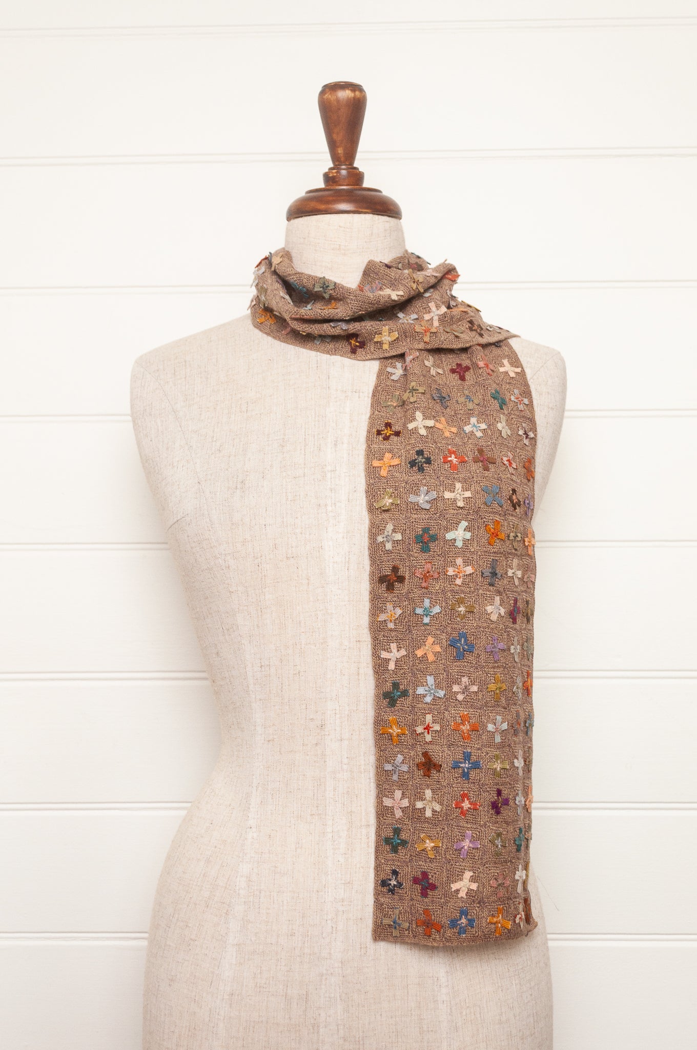 Sophie Digard crochet scarf of multi coloured four petal flowers on nutmeg brown base.