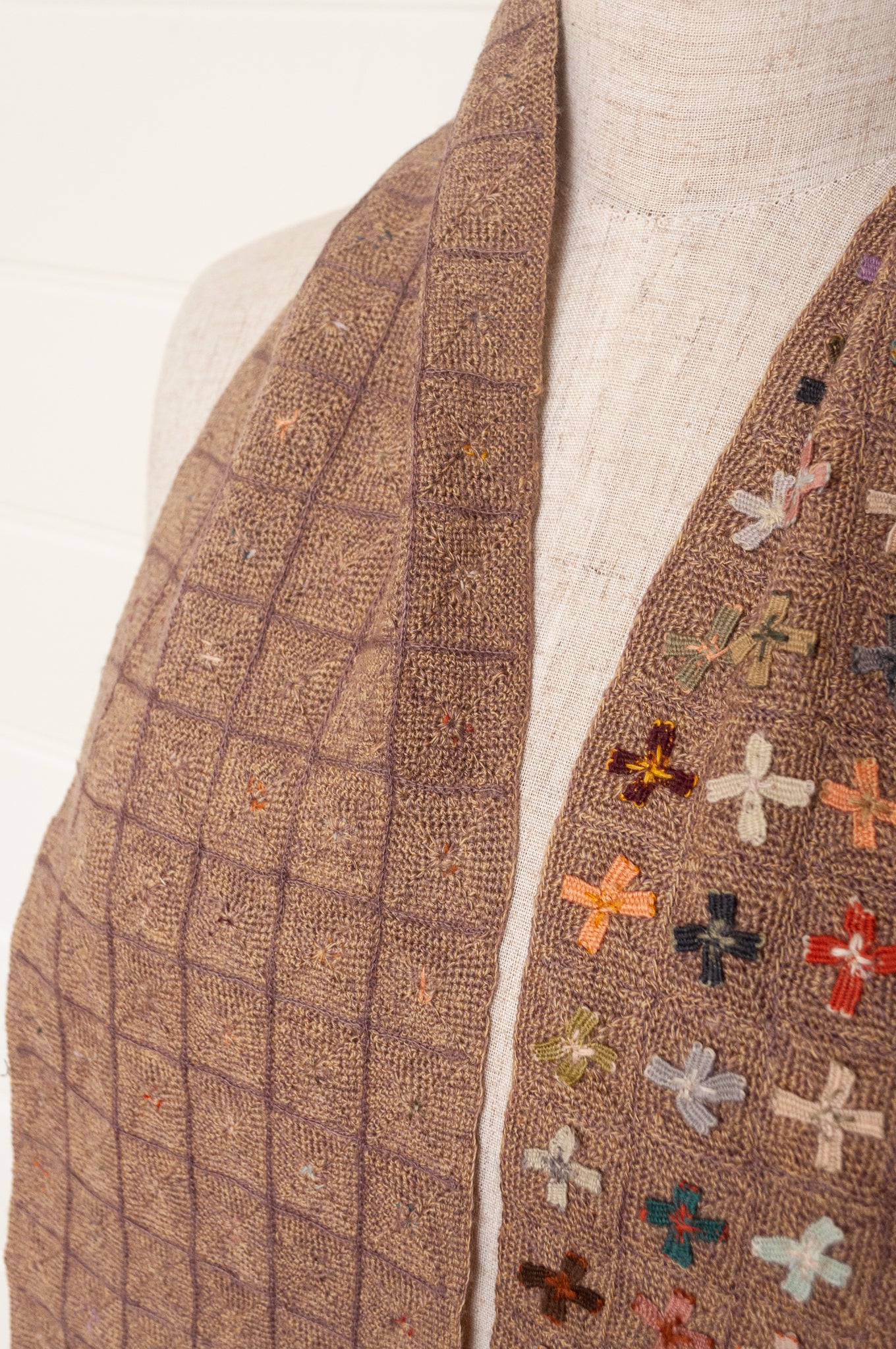 Sophie Digard crochet scarf of multi coloured four petal flowers on nutmeg brown base.