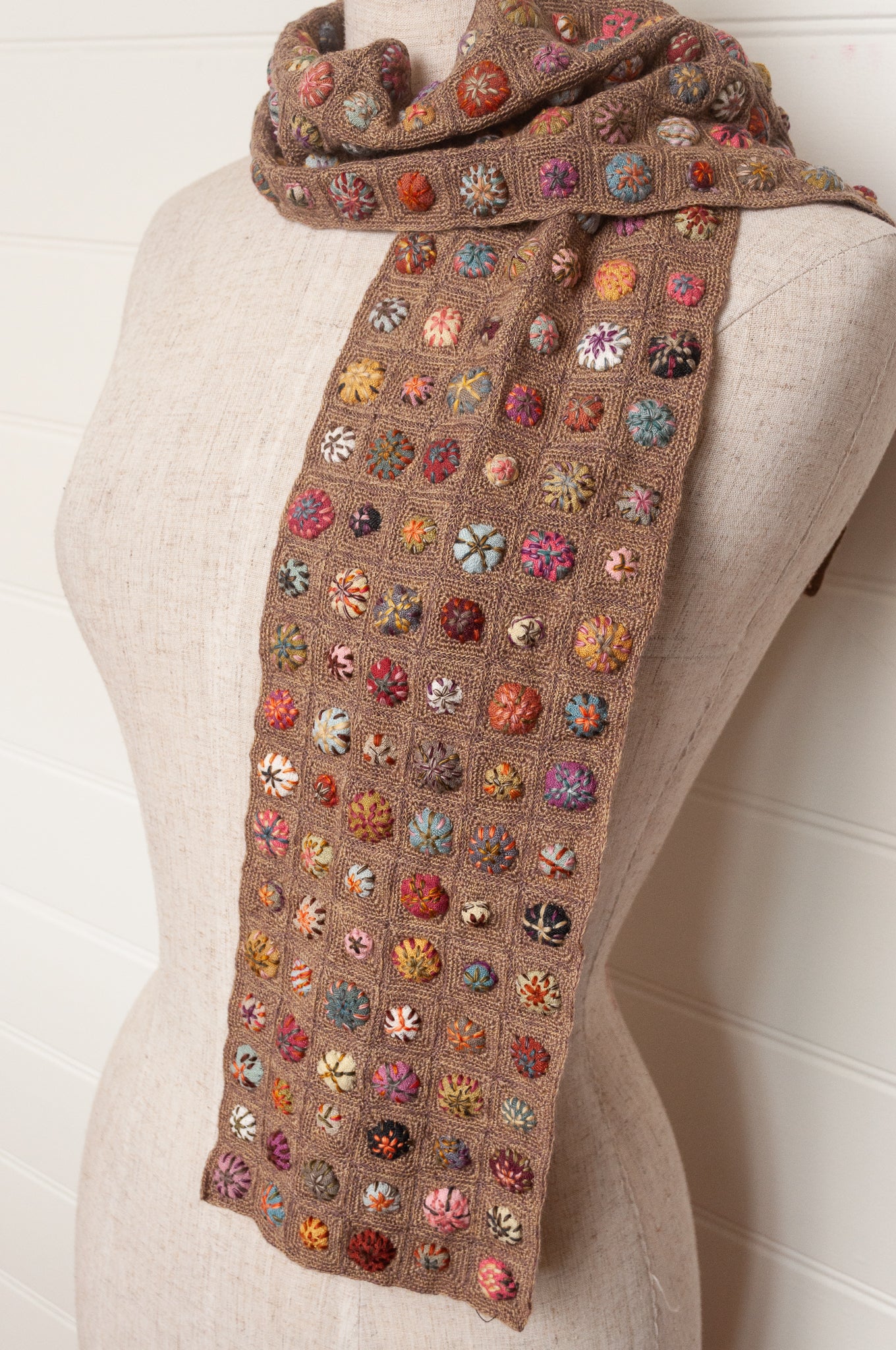 Sophie Digard  crocheted scarf of squares in nutmeg brown with multi-coloured embroidered fabric buttons.