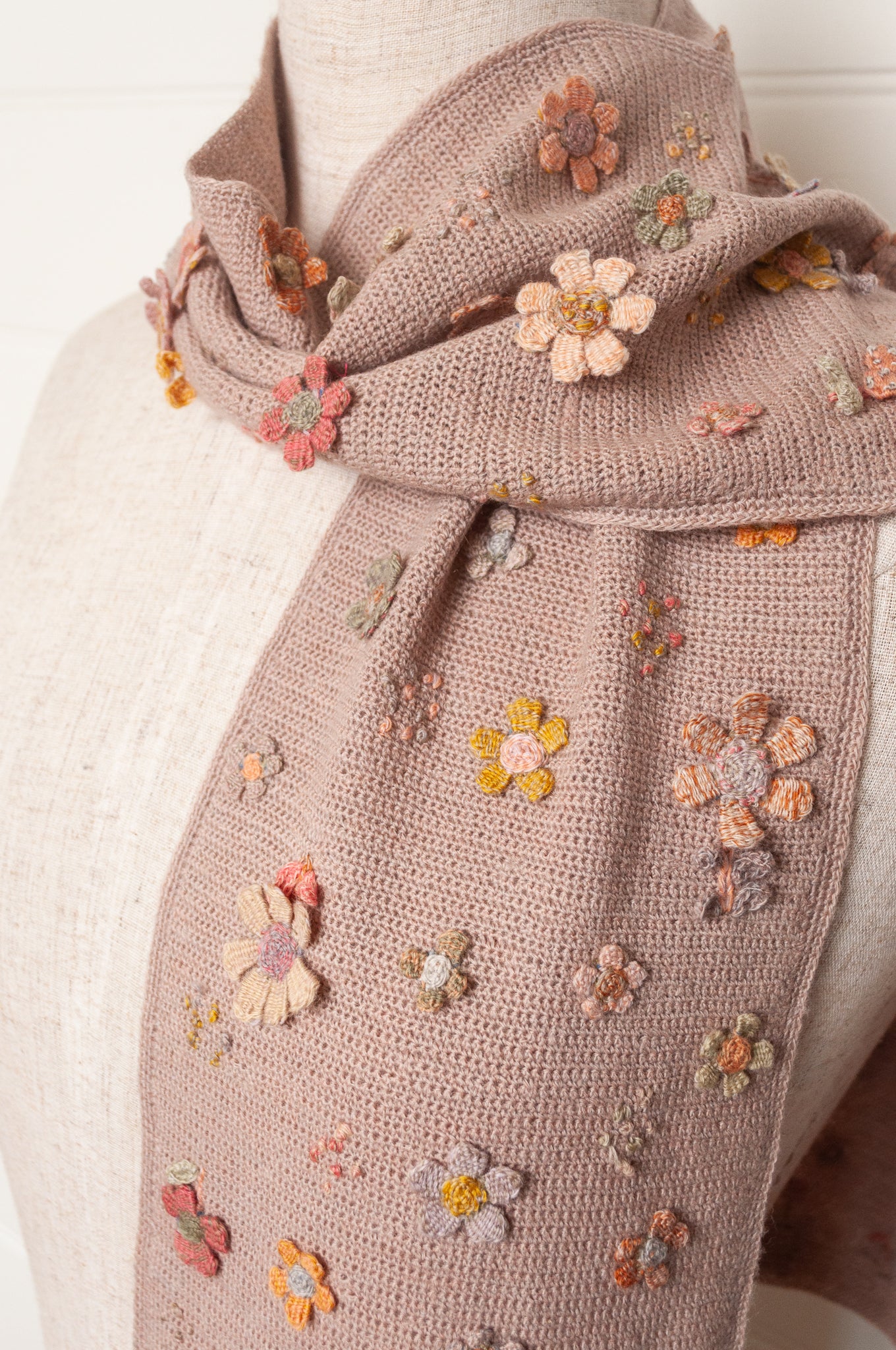 Sophie Digard flower sampler crocheted scarf in soft pastel palette on lilac base.