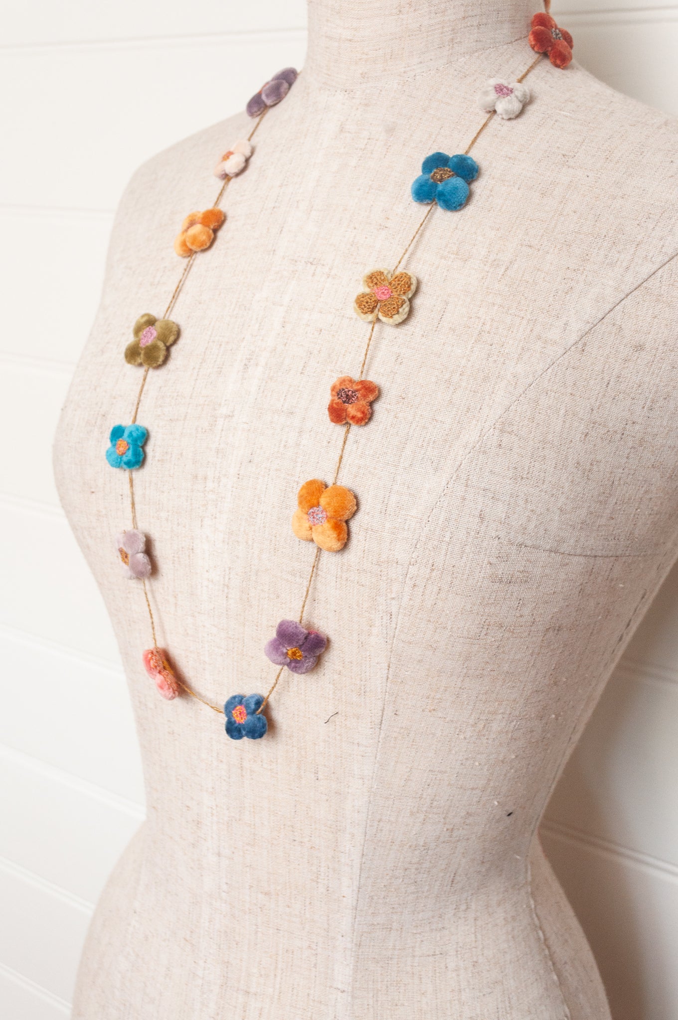 Sophie Digard velvet four petal flower necklace in bright pastels.
