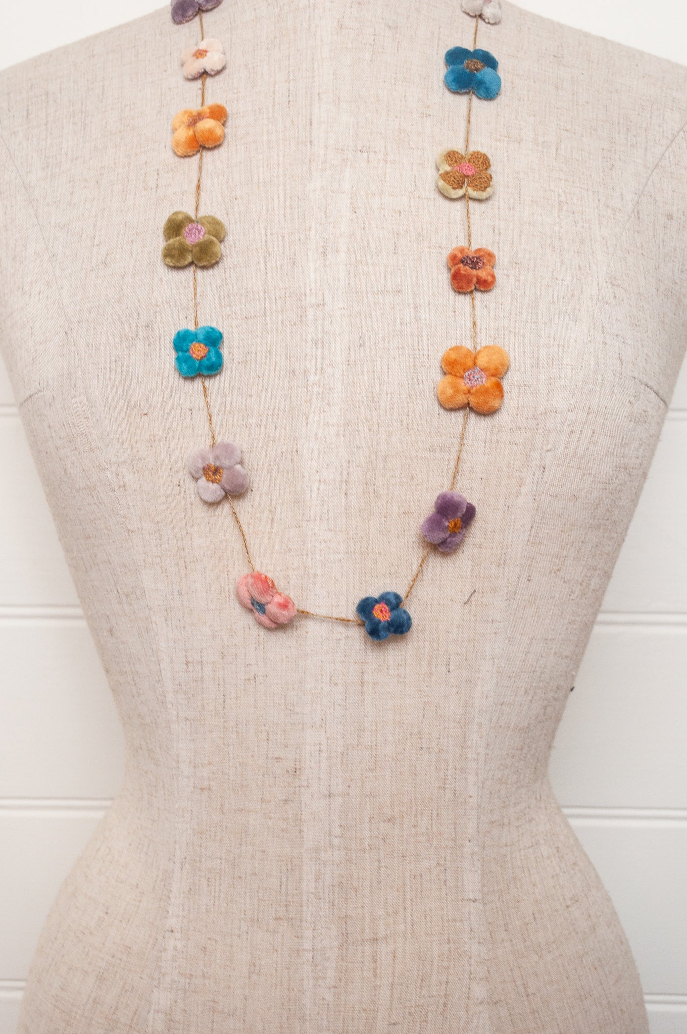 Sophie Digard velvet four petal flower necklace in bright pastels.