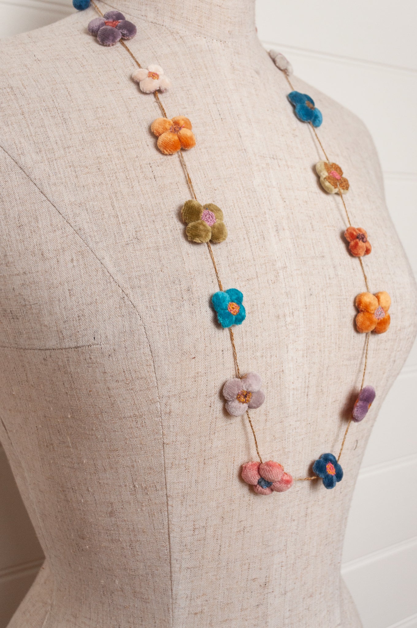 Sophie Digard velvet four petal flower necklace in bright pastels.