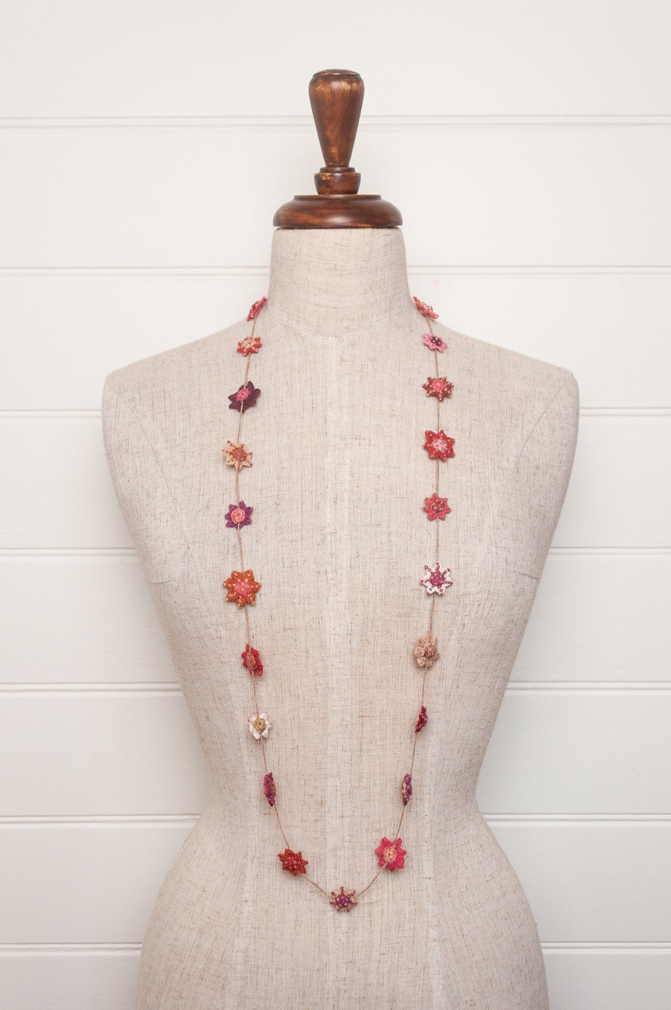 Sophie Digard star flower embroidered linen necklace in pinks and reds.
