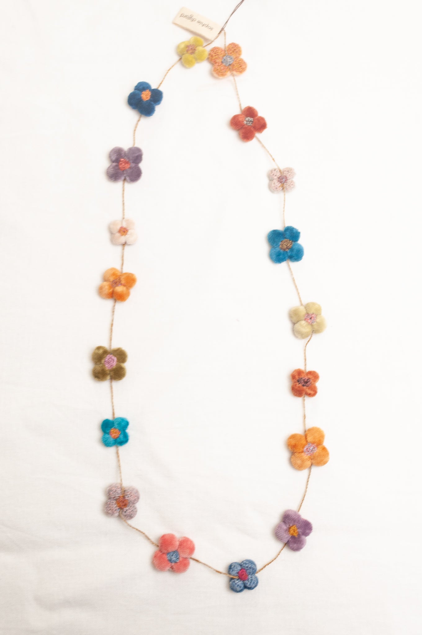 Sophie Digard velvet four petal flower necklace in bright pastels.
