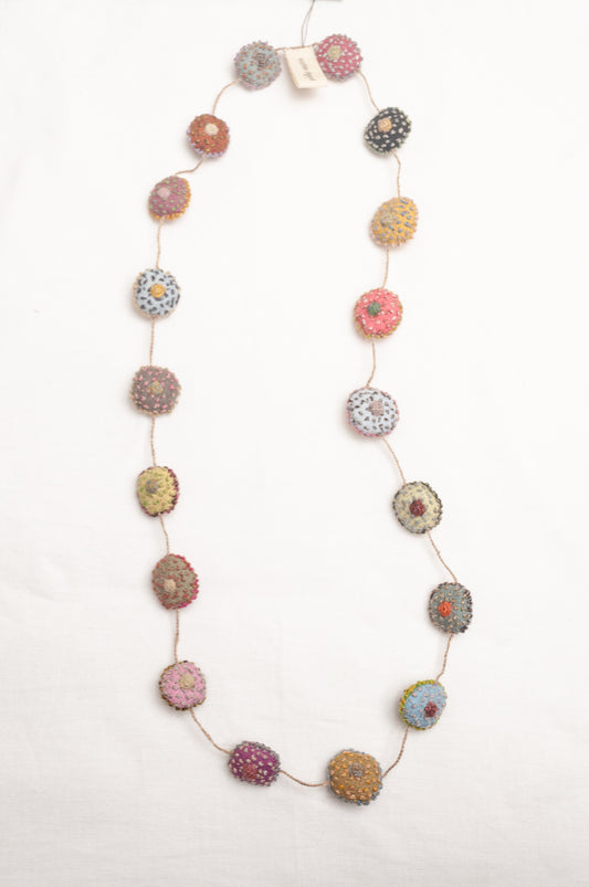 Sophie Digard necklace of embroidered linen medallions.