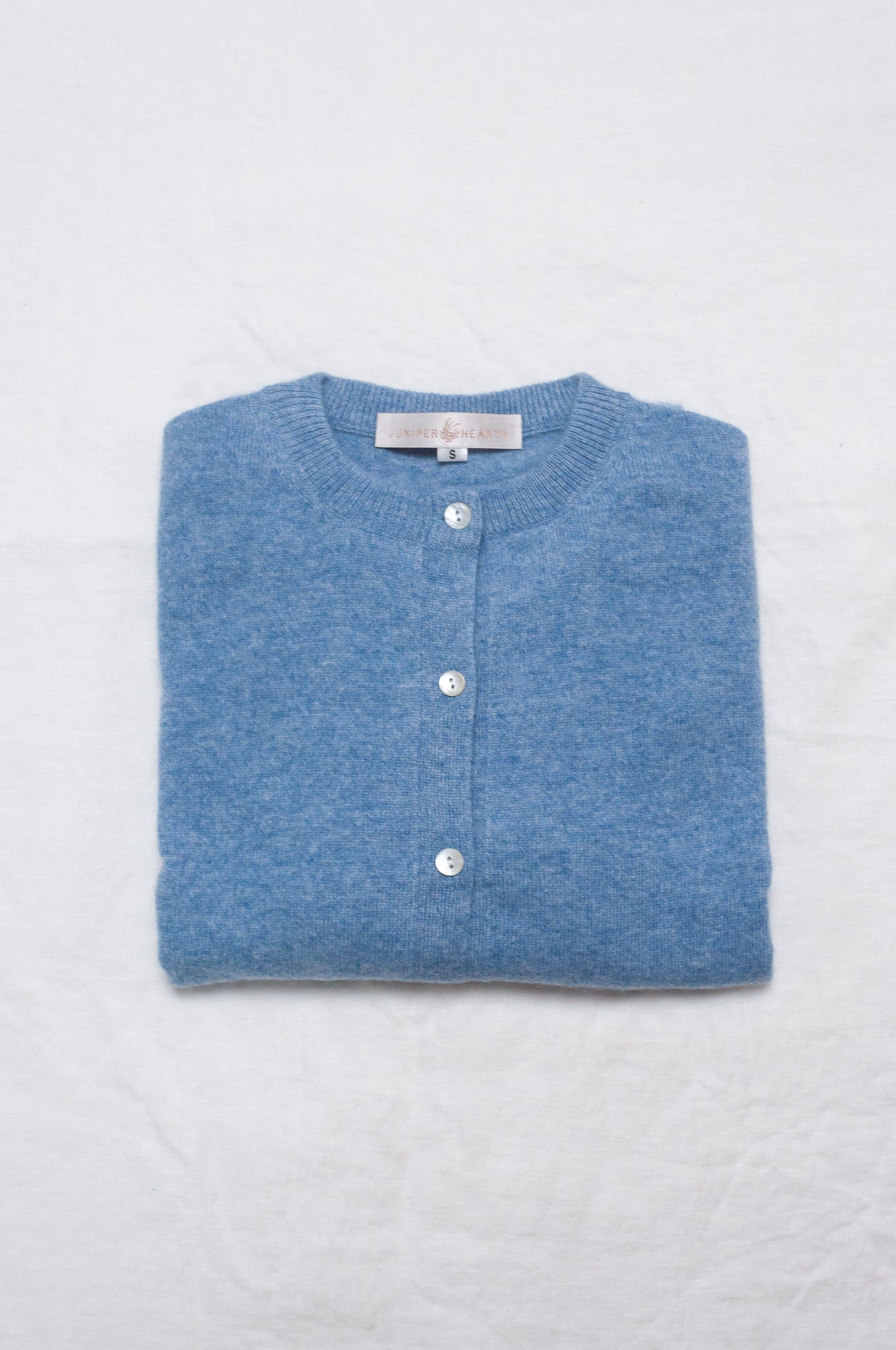 Juniper Hearth 100% cashmere button up crew neck cropped cardigan in sky blue.