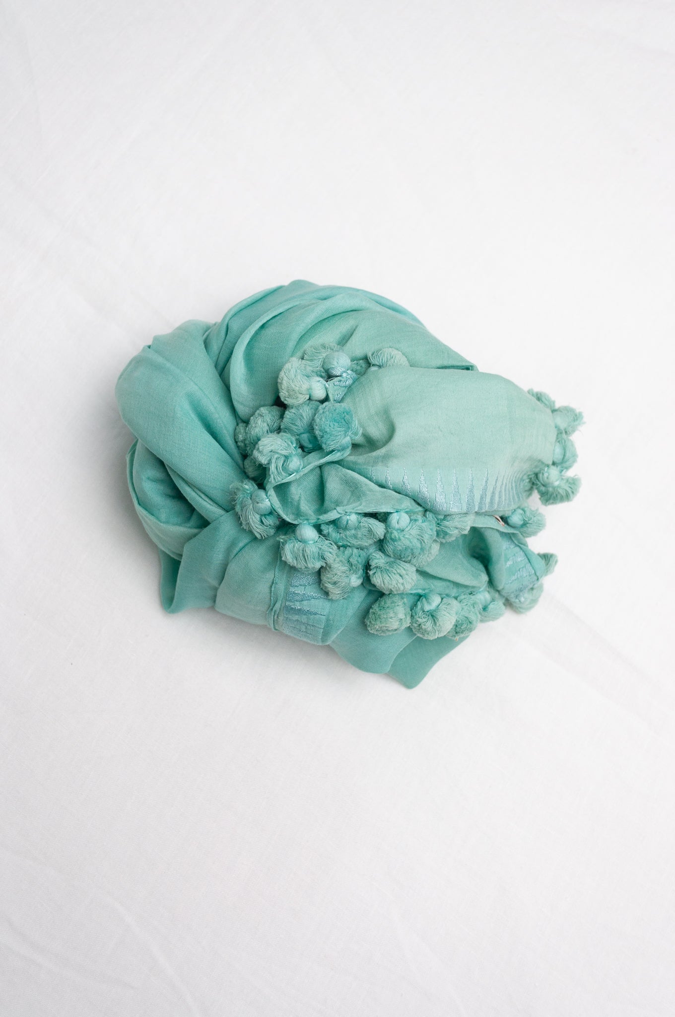 Silk cotton pom pom scarf in celeste aqua blue.