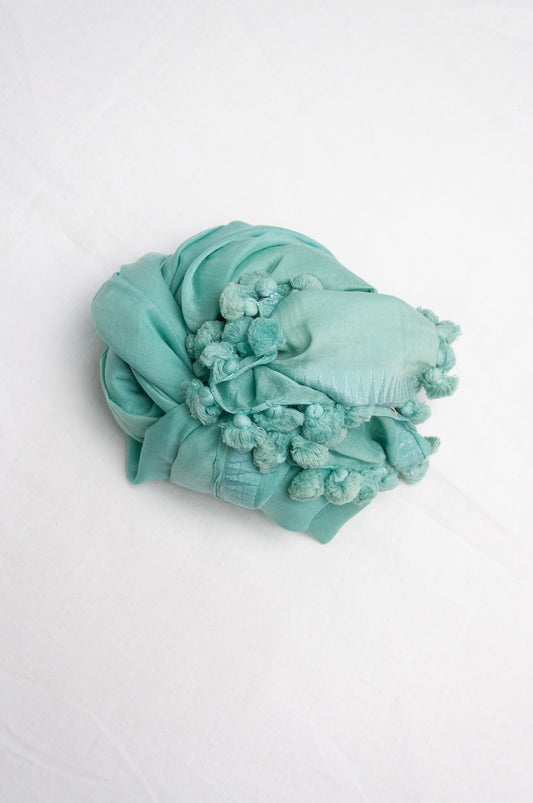 Silk cotton pom pom scarf in celeste aqua blue.