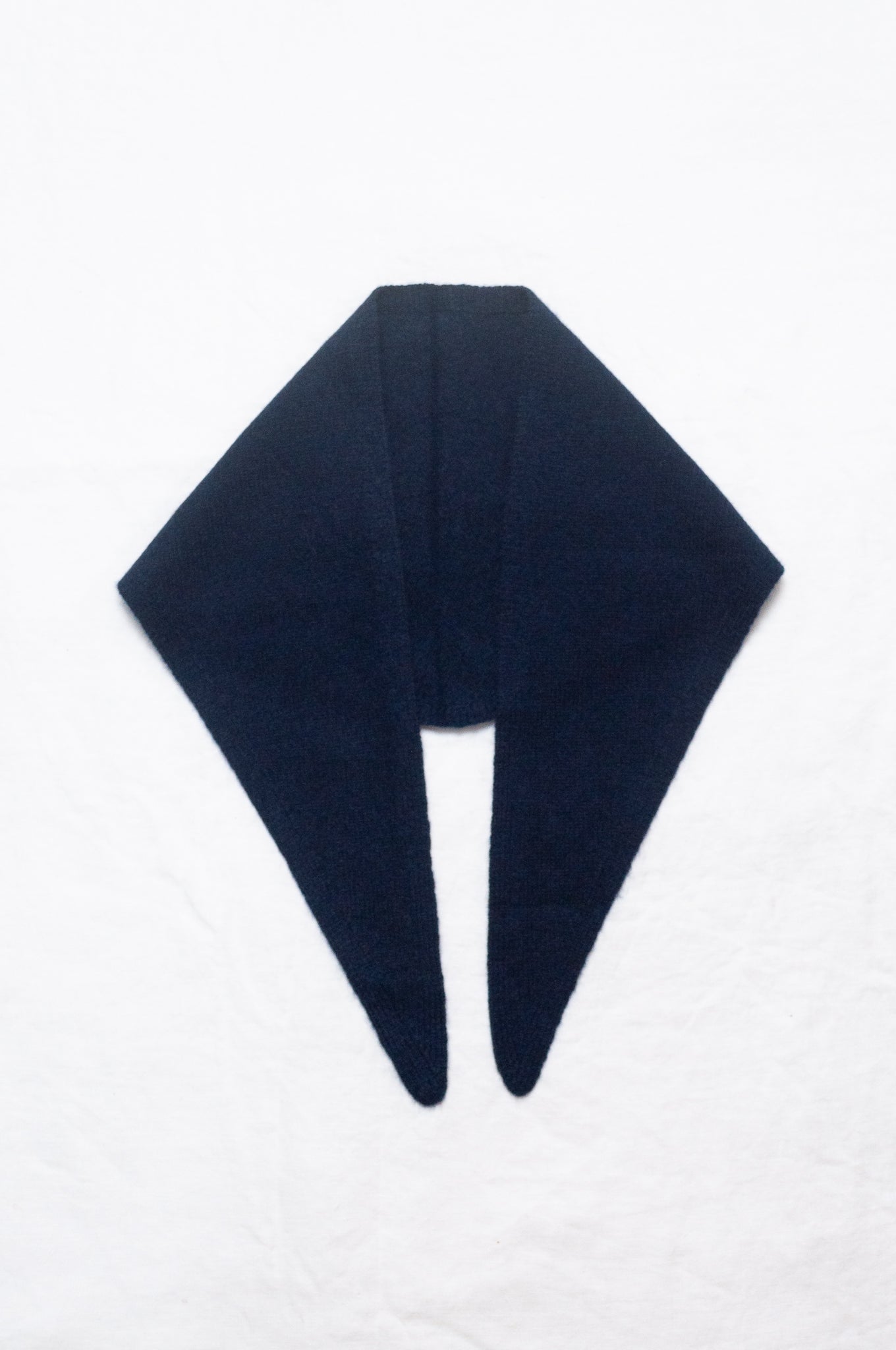 Cashmere triangle neck scarf in deep navy blue.