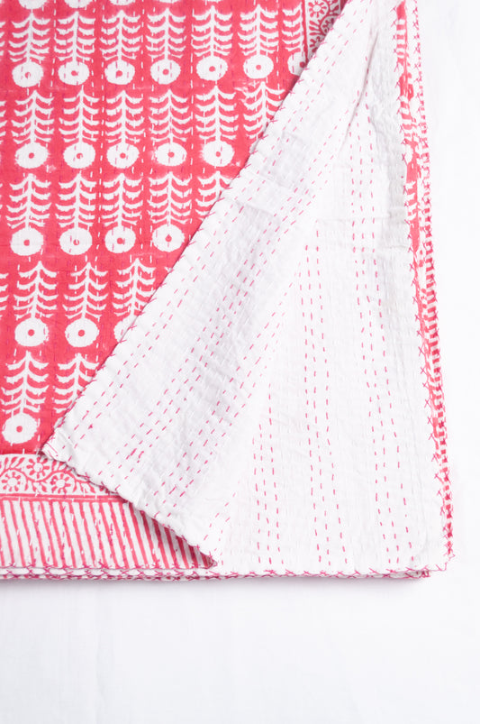 Pink and white floral blockprint cotton kantha quilt.