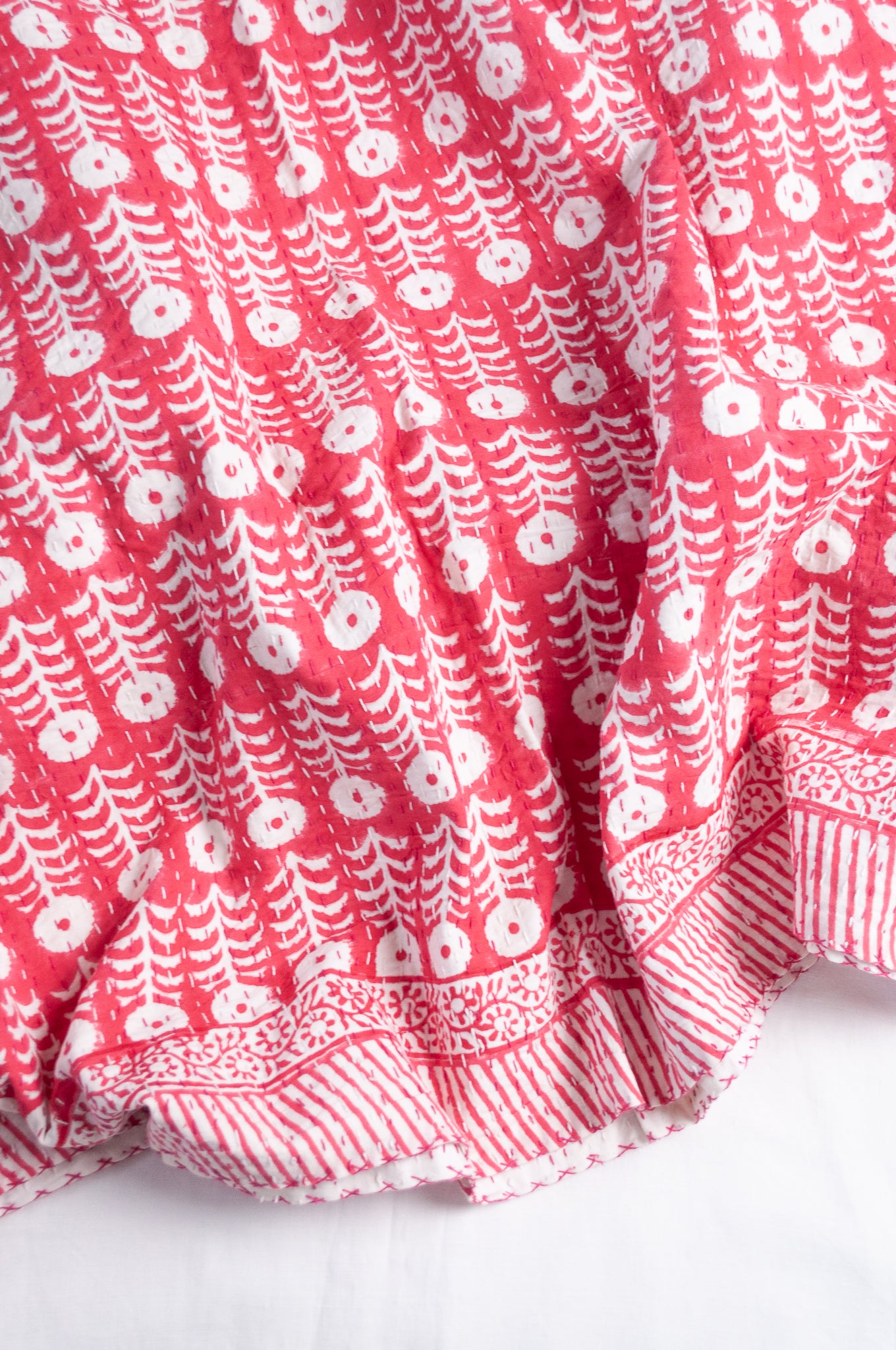 Pink and white floral blockprint cotton kantha quilt.