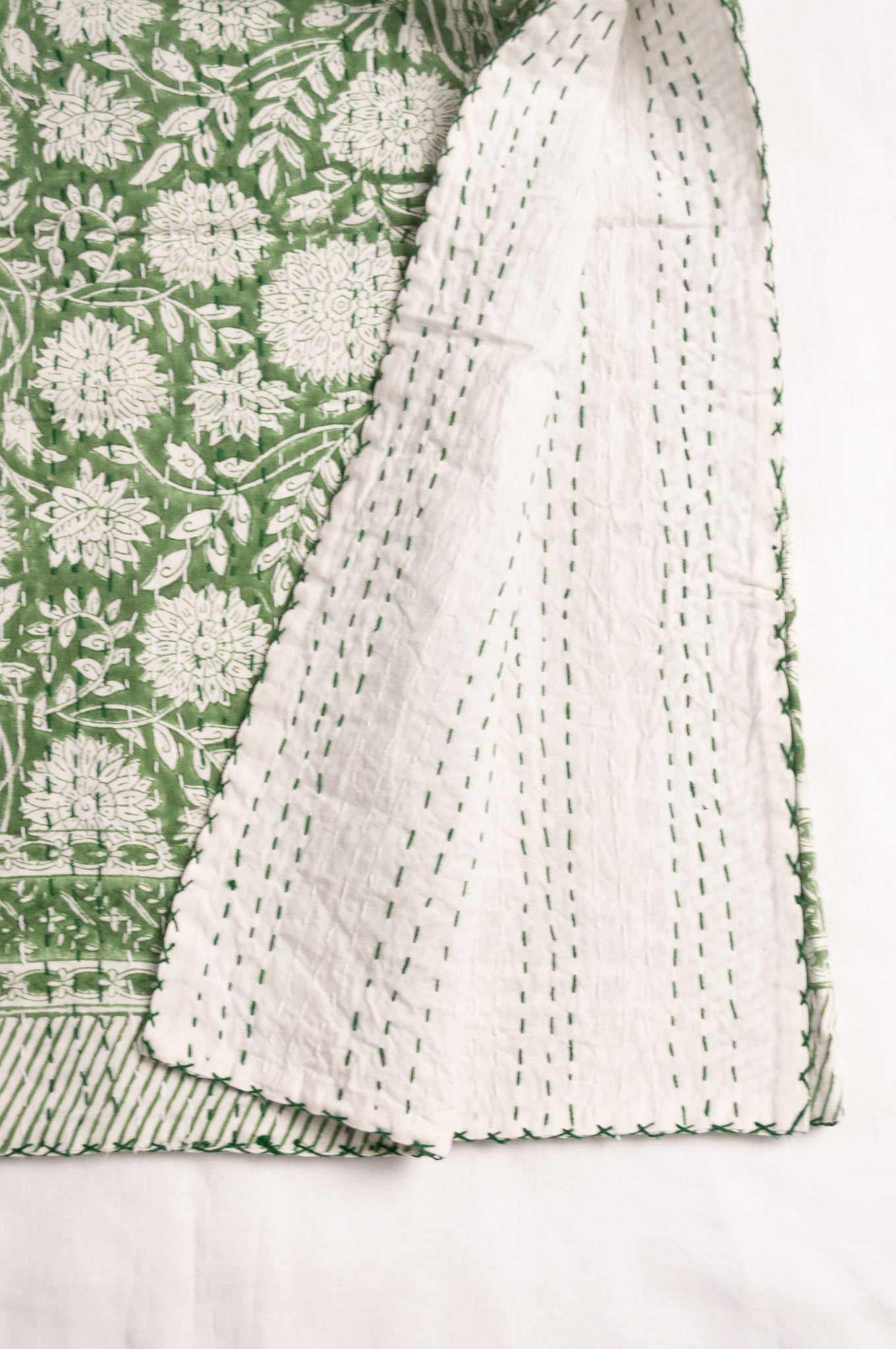Cotton kantha quilt in grass green and white floral.