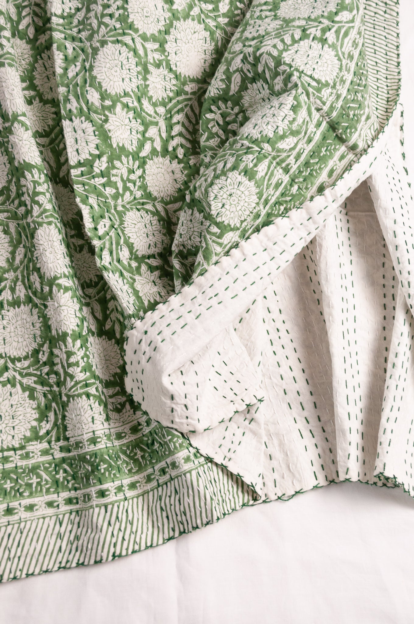 Cotton kantha quilt in grass green and white floral.