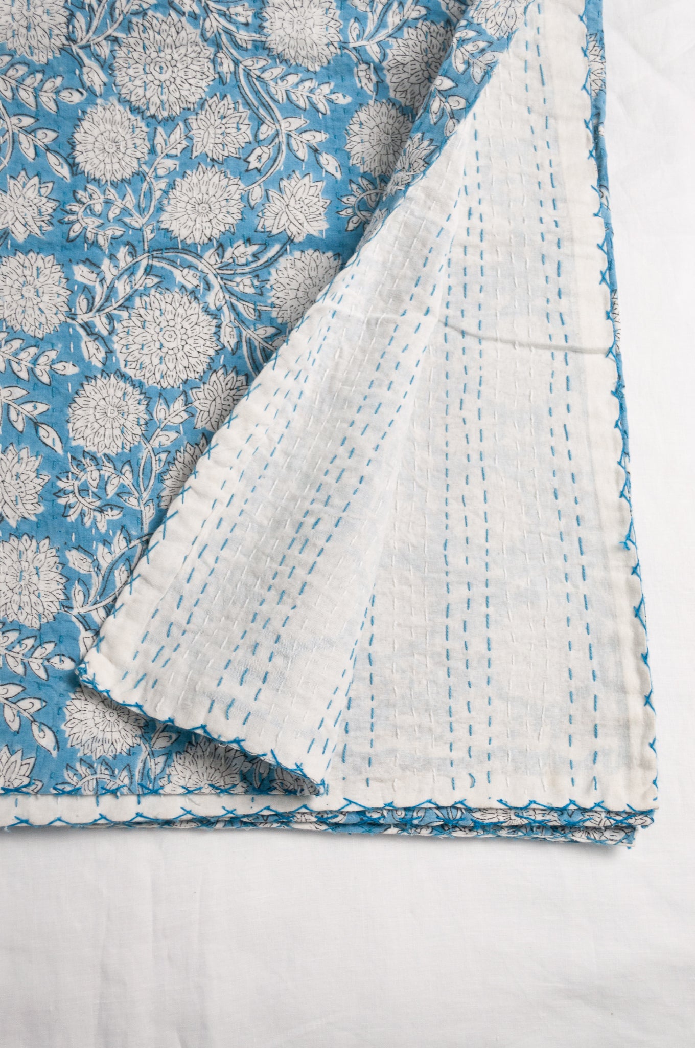 Cotton kantha quilt in sky blue and white floral.