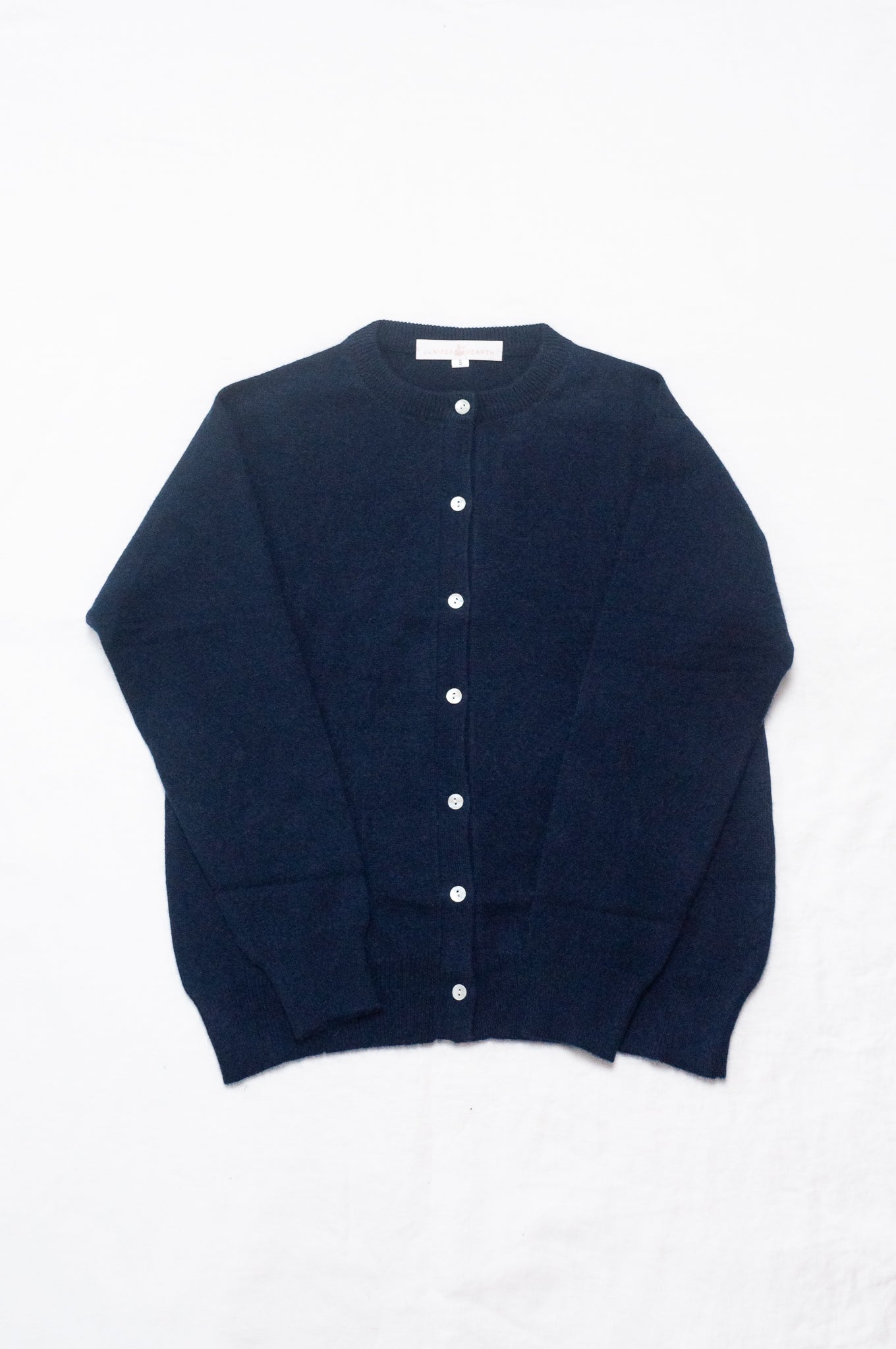 Classic cashmere crew neck cardigan in deep midnight navy blue.