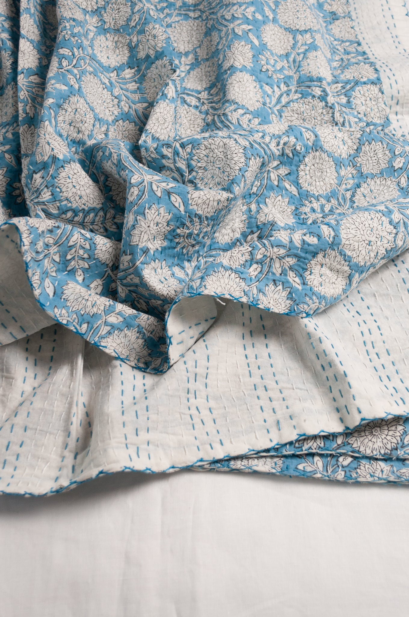 Cotton kantha quilt in sky blue and white floral.
