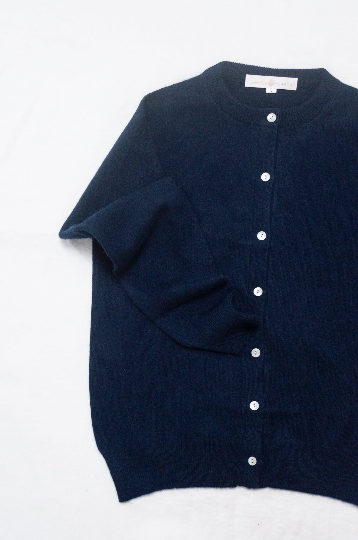 Classic cashmere crew neck cardigan in deep midnight navy blue.