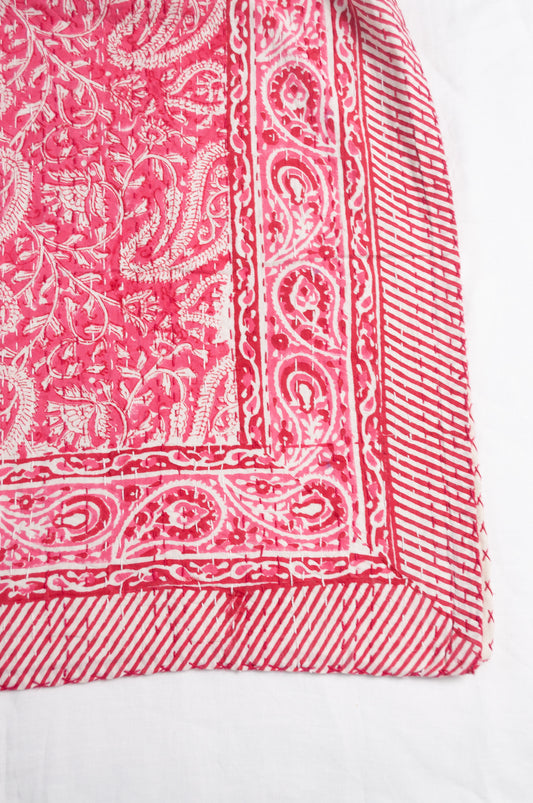 Raspberry pink and white paisley cotton kantha quilt.