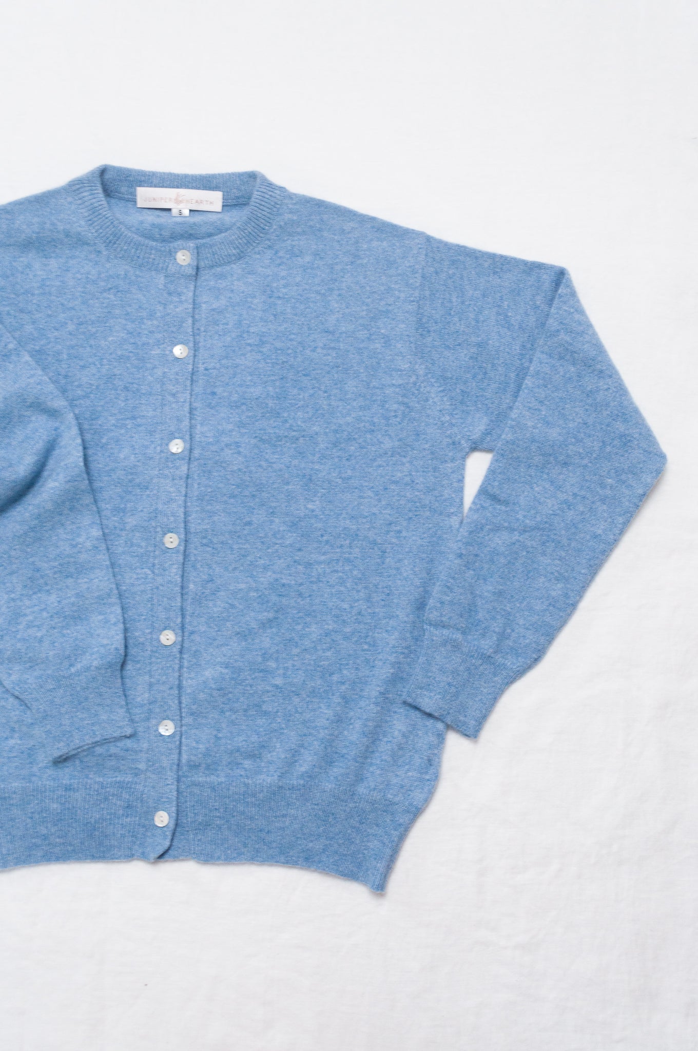 Juniper Hearth 100% cashmere button up crew neck cropped cardigan in sky blue.