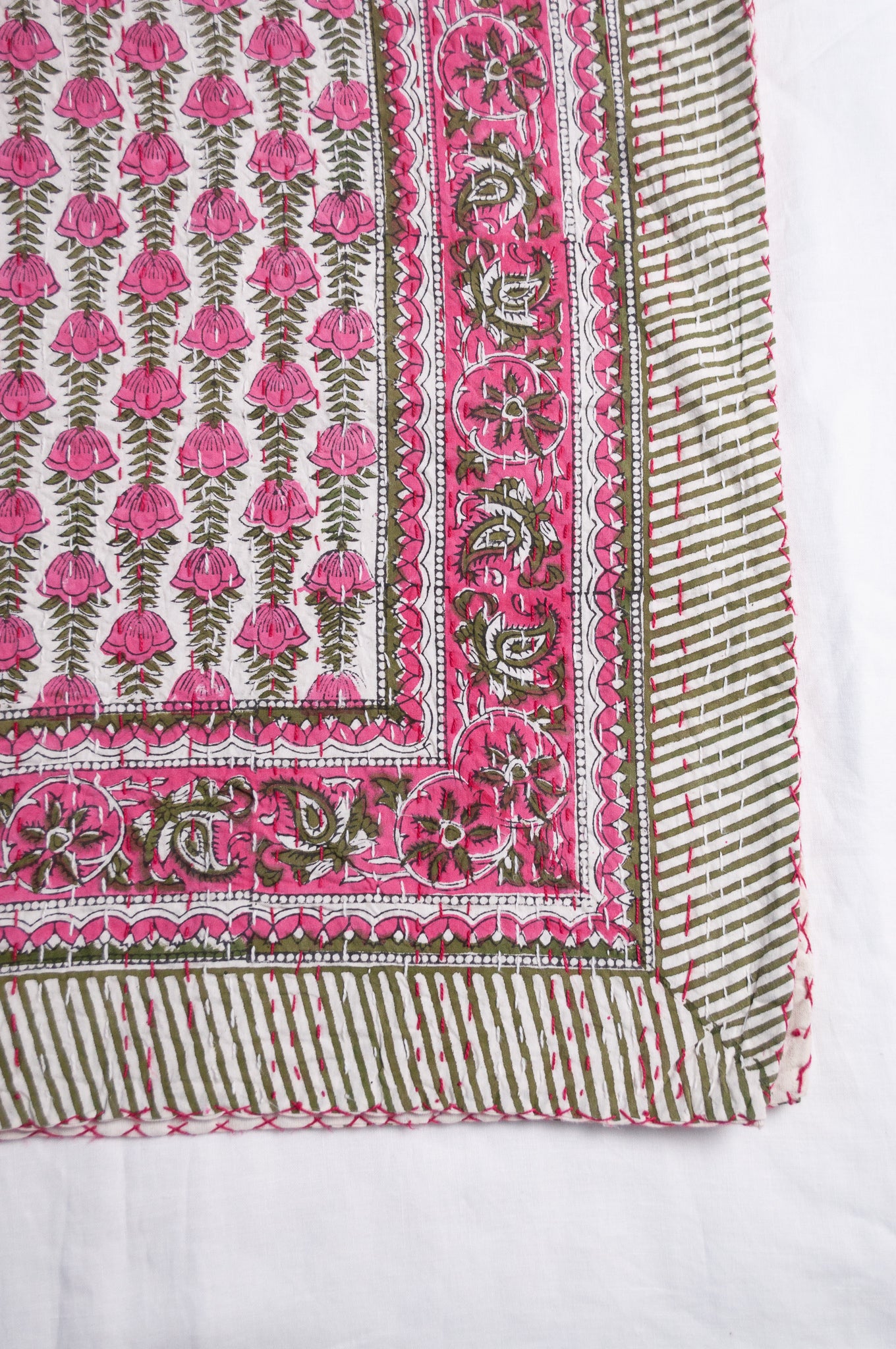 Pink green and white floral cotton kantha quilt.