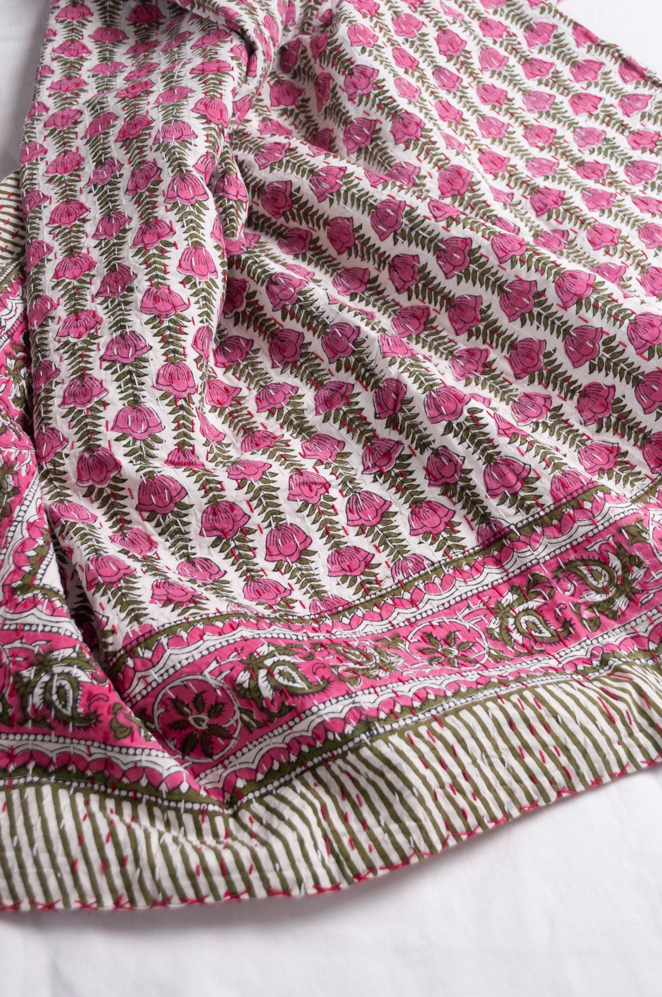 Pink green and white floral cotton kantha quilt.