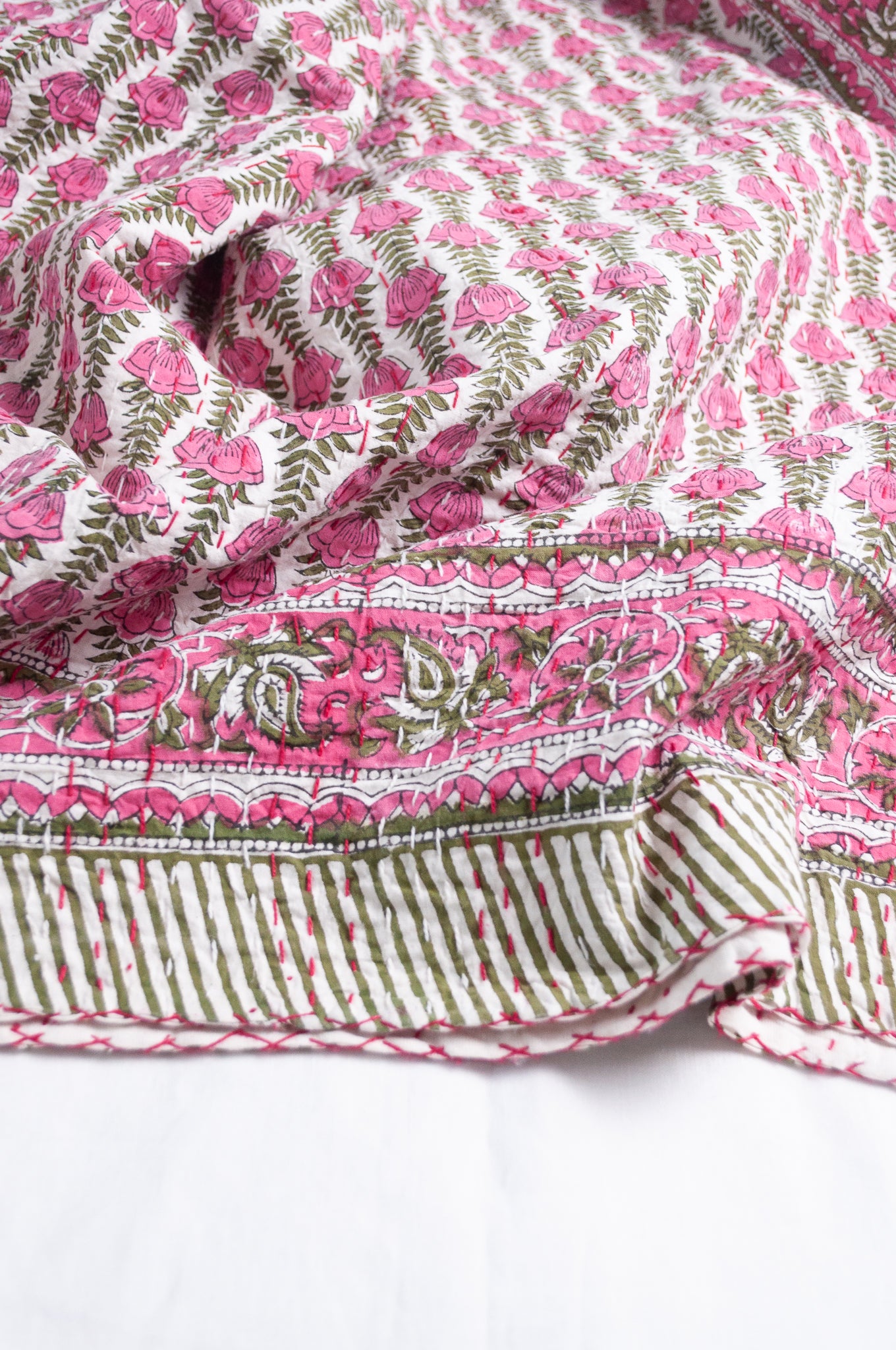 Pink green and white floral cotton kantha quilt.