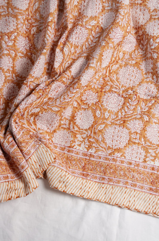 Cotton kantha quilt in mustard yellow and white floral.