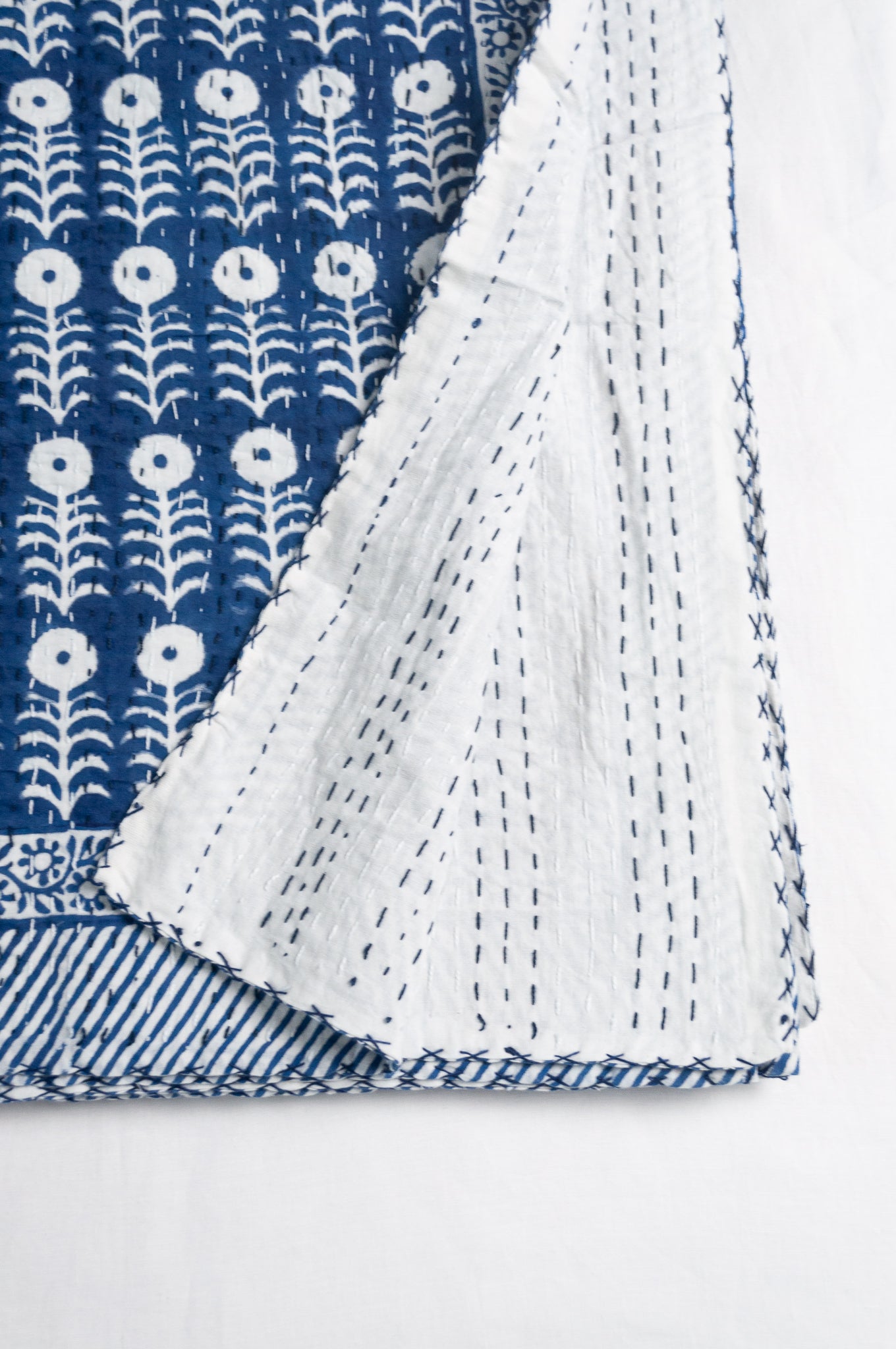 Blue and white floral cotton blockprint kantha quilt.