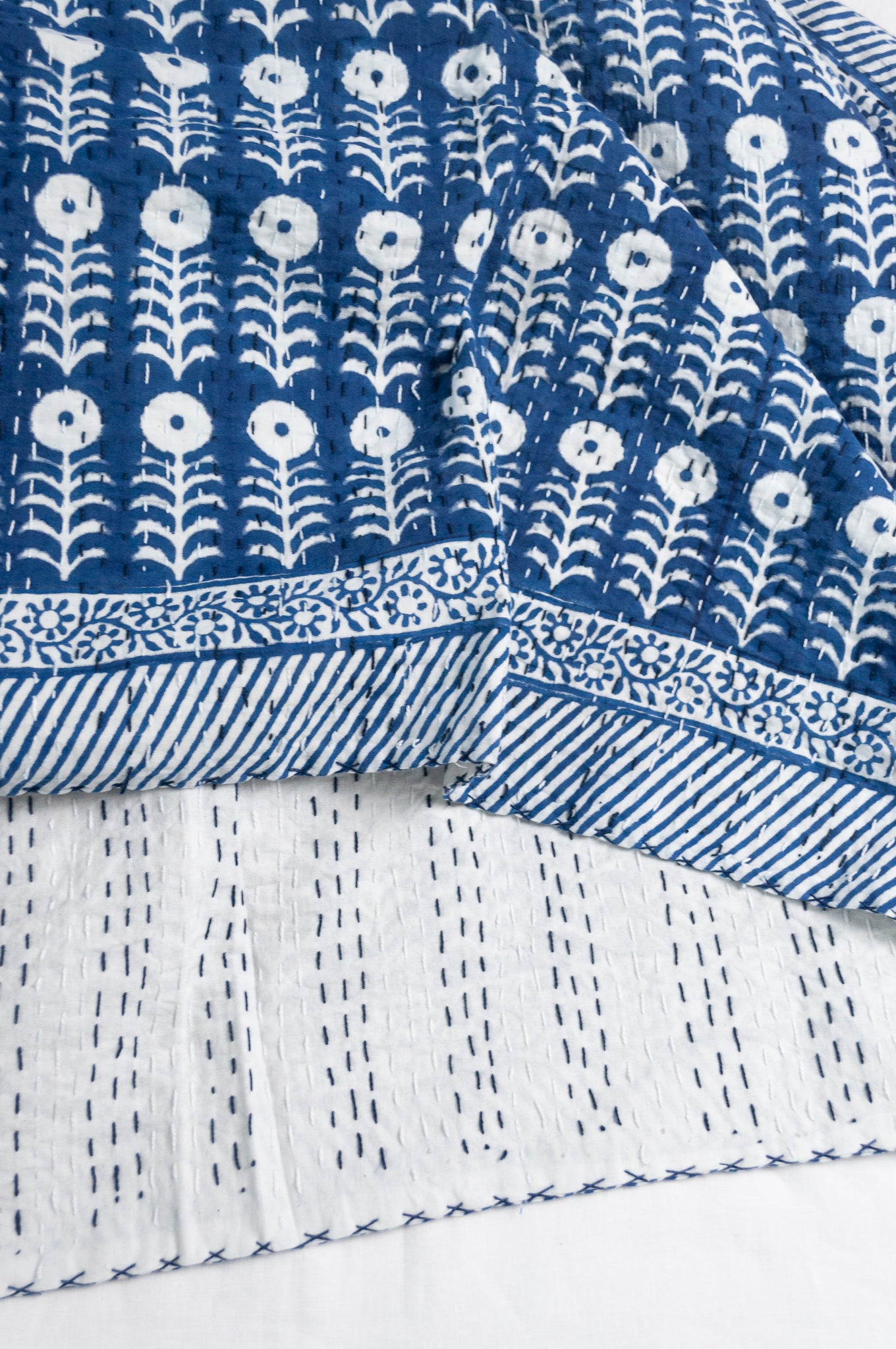 Blue and white floral cotton blockprint kantha quilt.