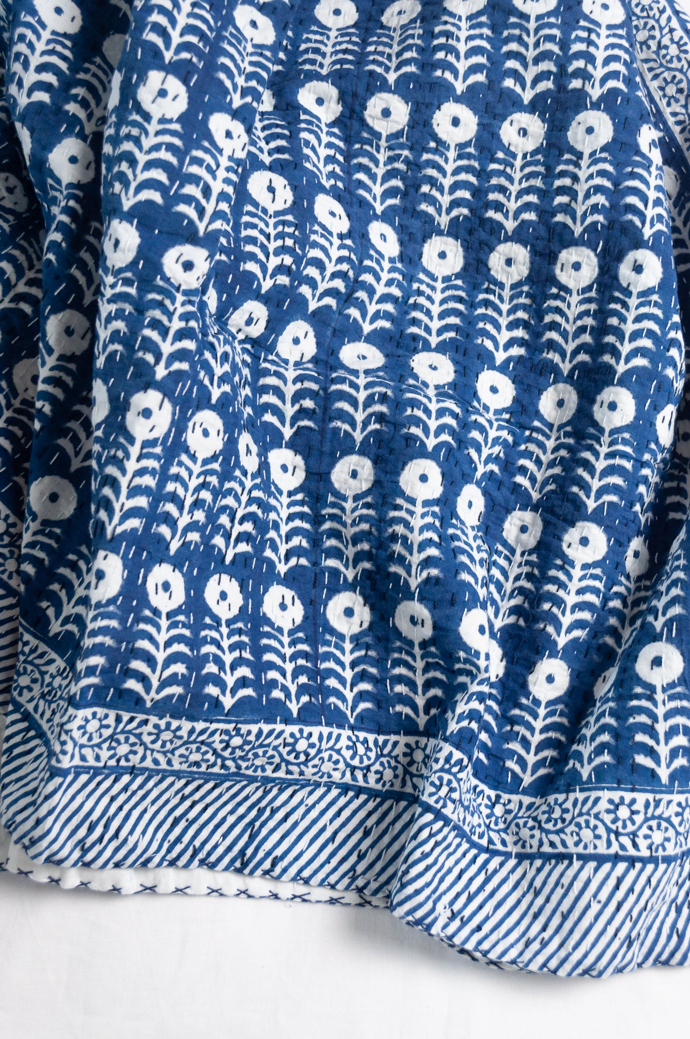 Blue and white floral cotton blockprint kantha quilt.
