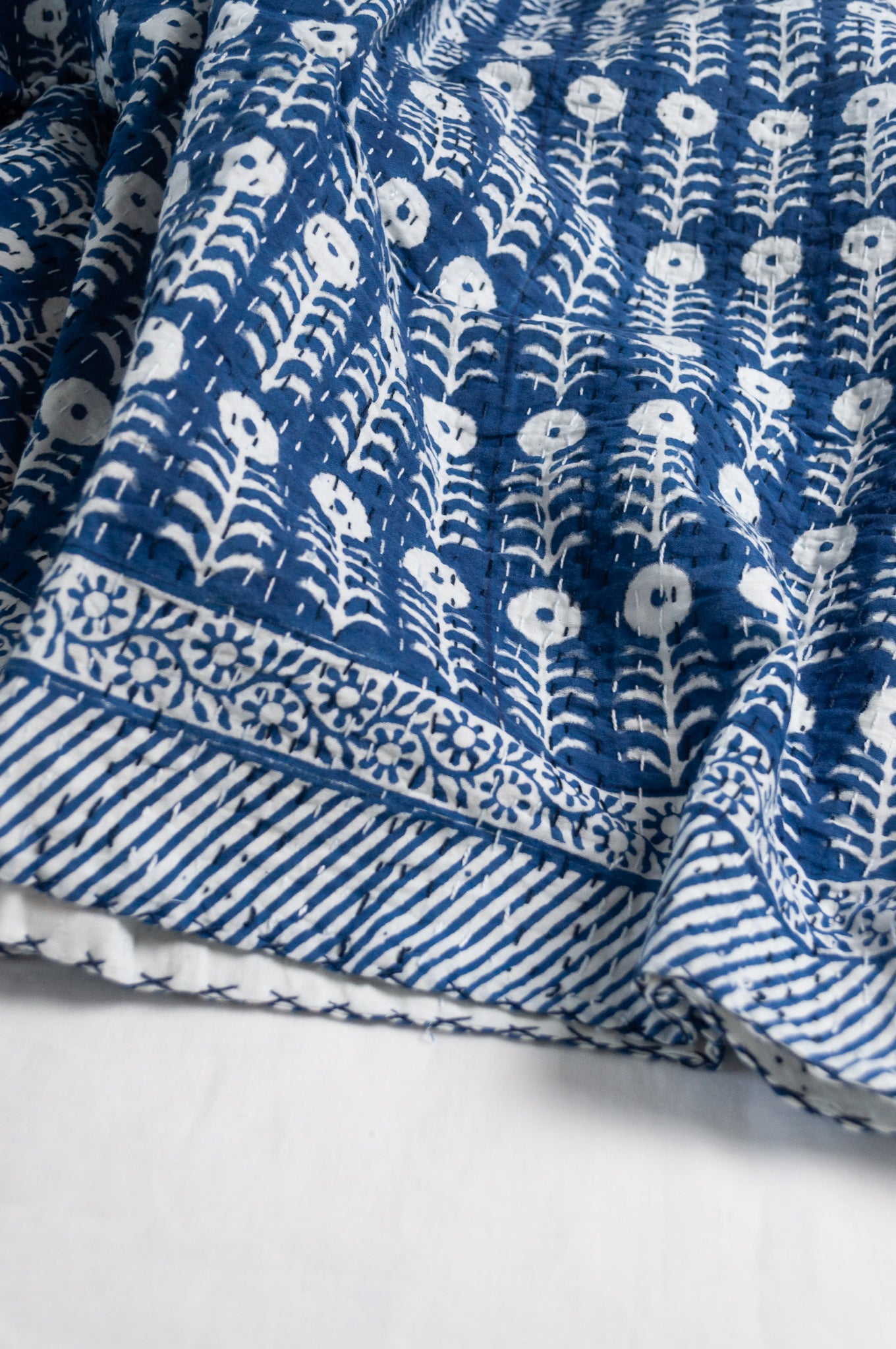 Blue and white floral cotton blockprint kantha quilt.