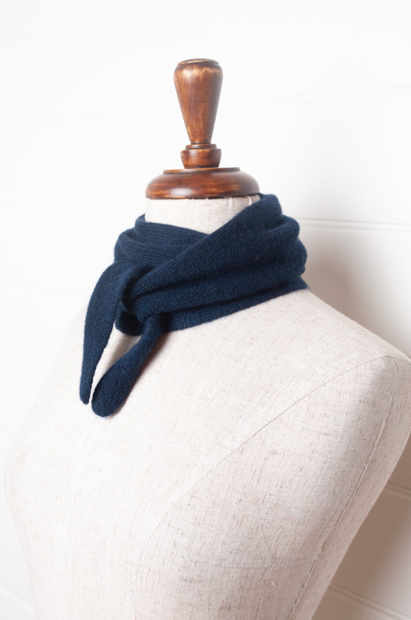 Cashmere triangle neck scarf in deep navy blue.