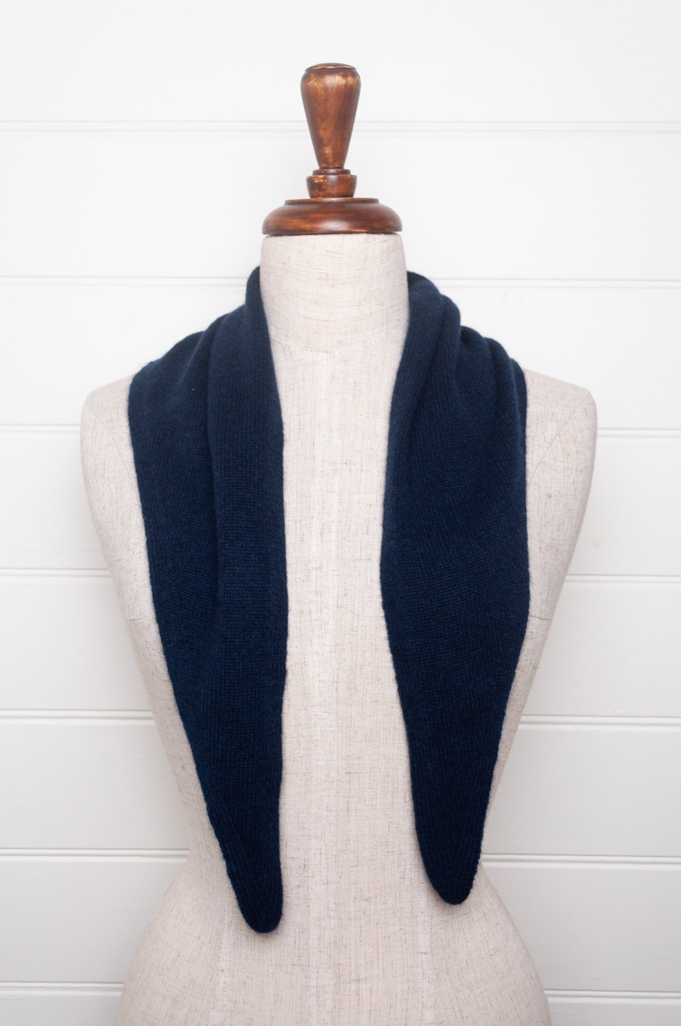 Cashmere triangle neck scarf in deep navy blue.