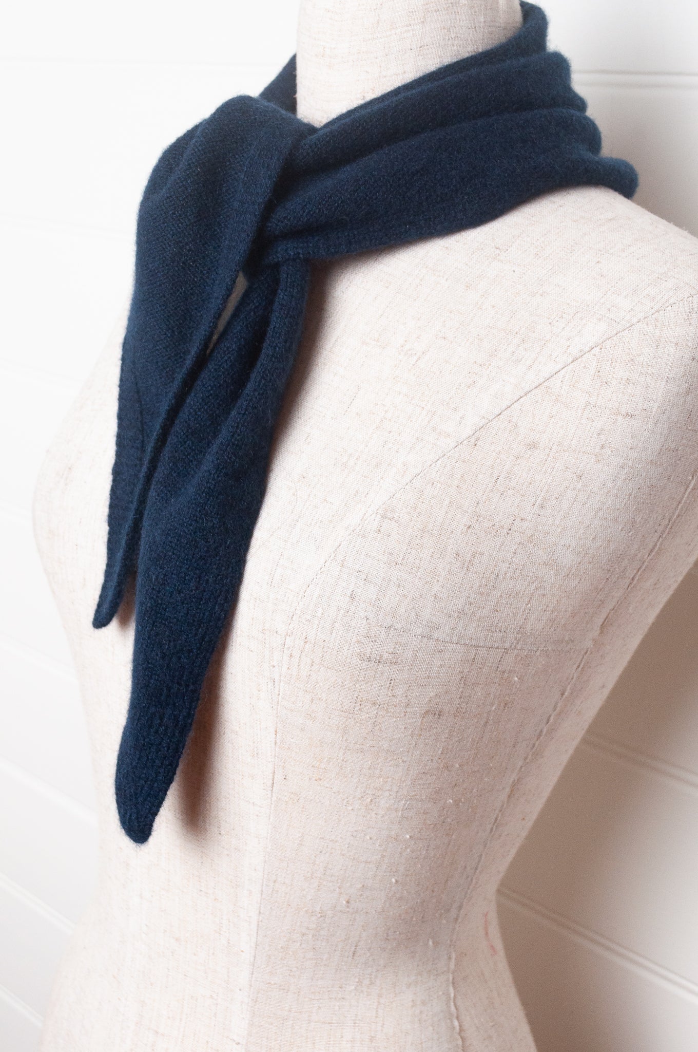 Cashmere triangle neck scarf in deep navy blue.