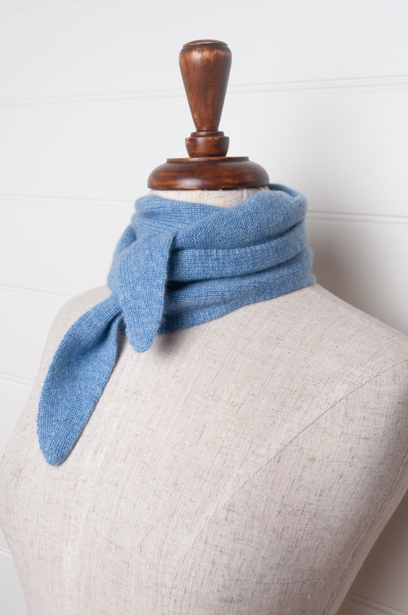 Cashmere triangle neck scarf in sky blue.