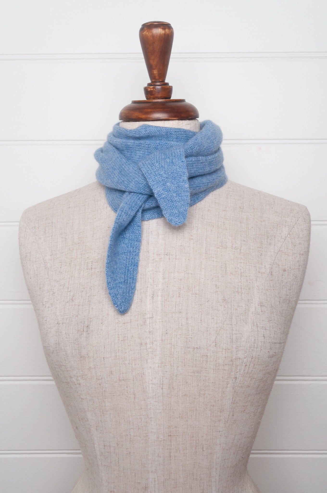 Cashmere triangle neck scarf in sky blue.